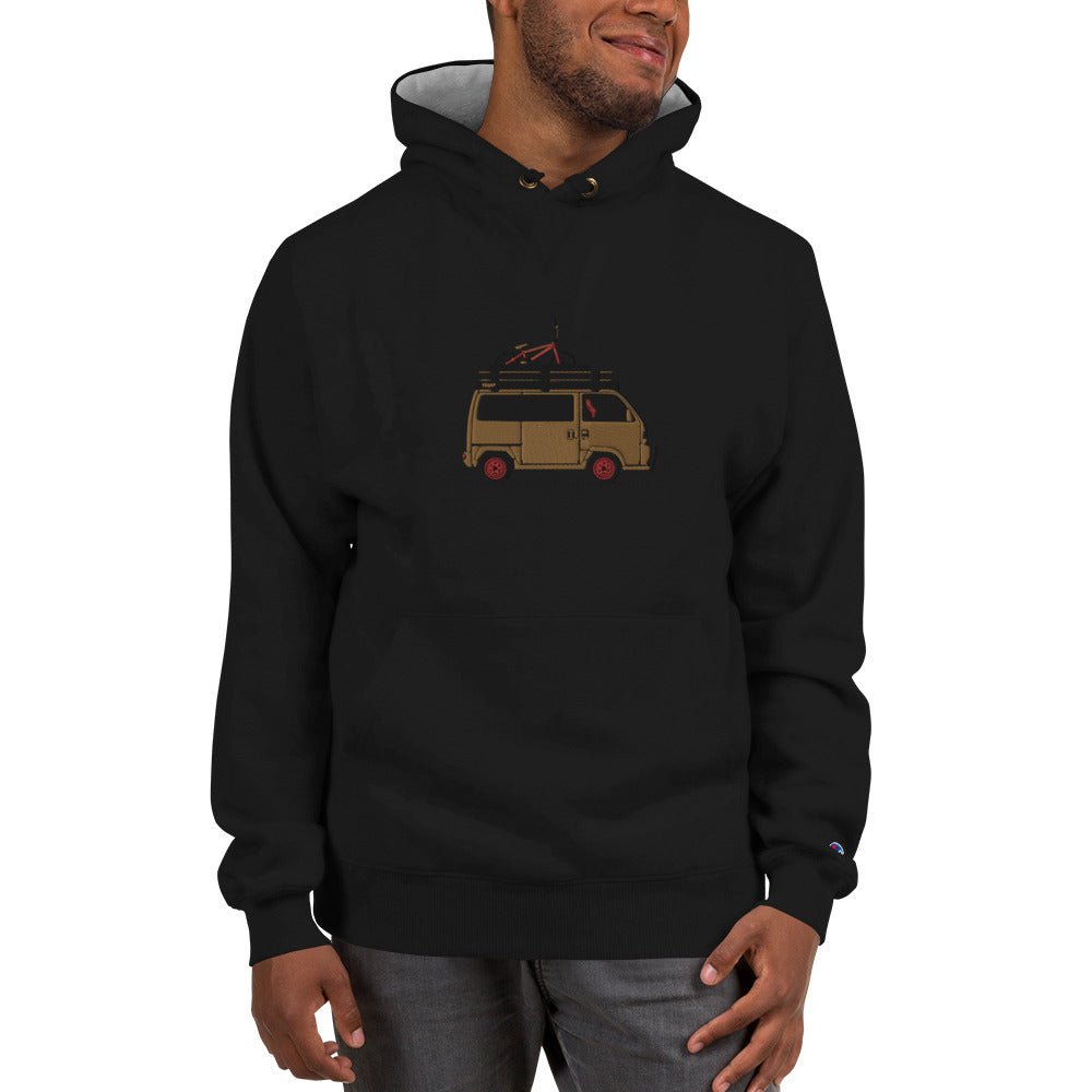 Black hoodie featuring an embroidered gold and red Honda Acty van design, worn by a smiling man against a neutral background