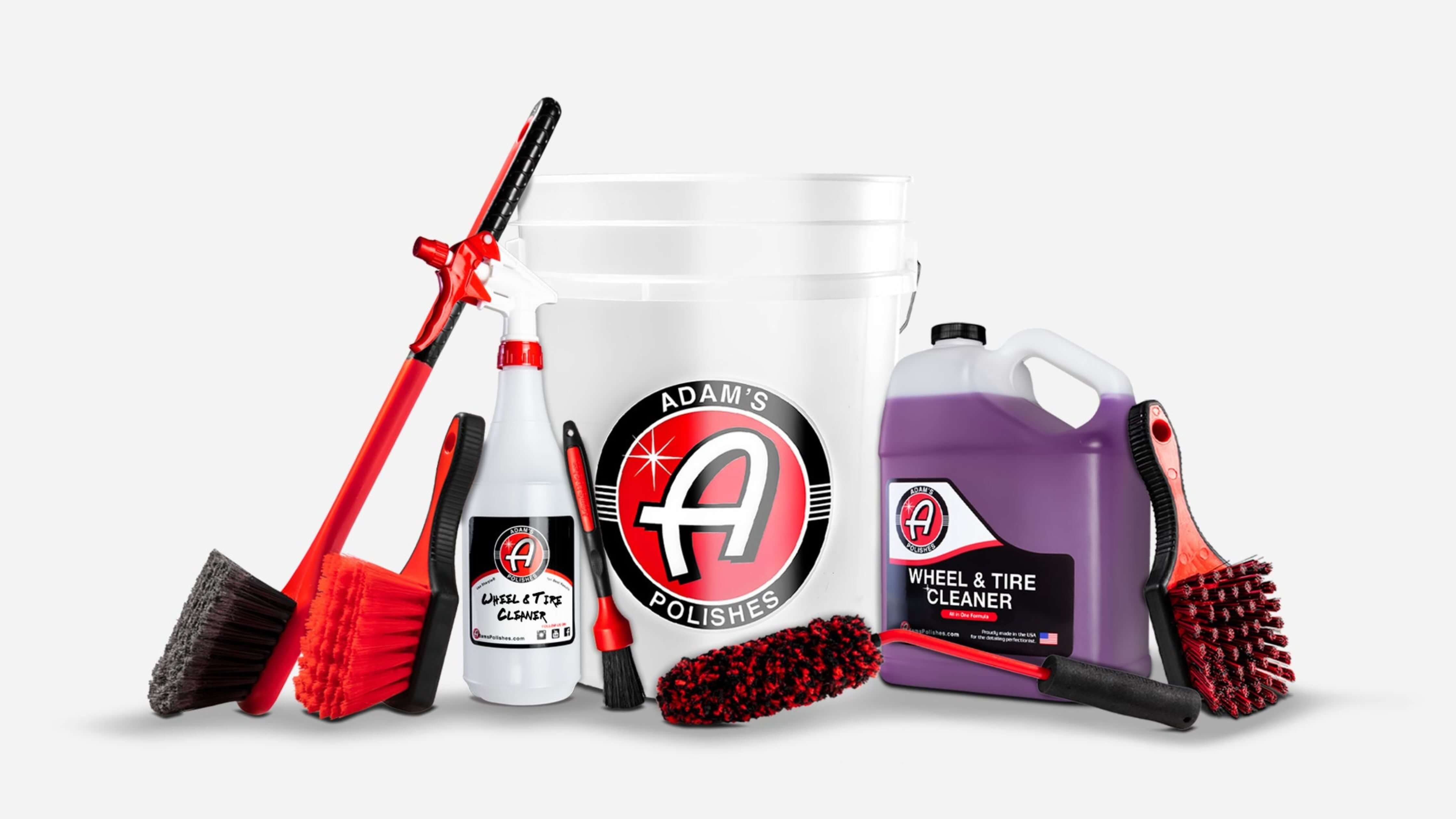 Adam's Polishes car detailing kit showcasing brushes, spray bottle, and tire cleaner for ultimate shine.