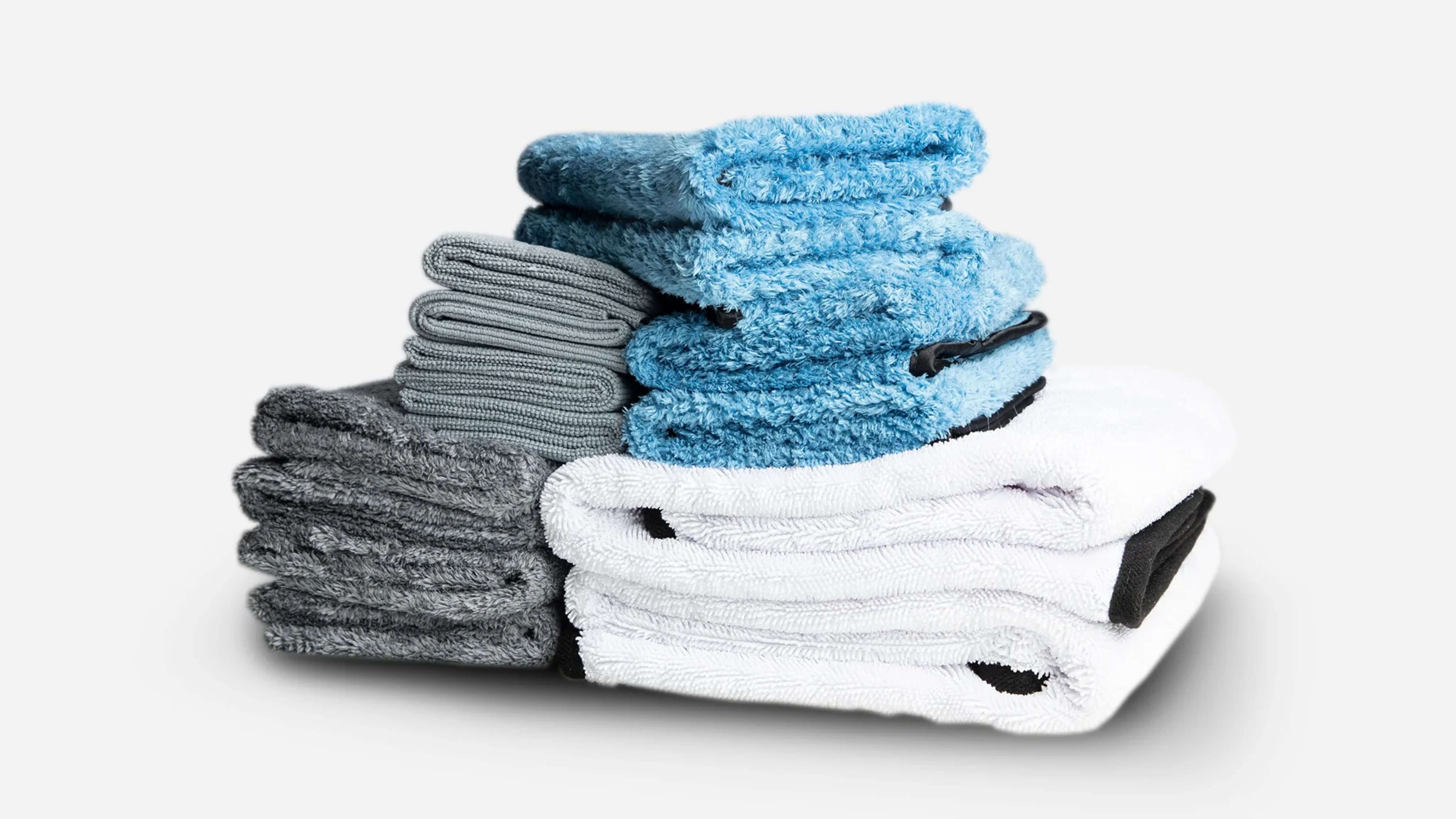 Stack of colorful microfiber towels illustrating GSM variety for car detailing.