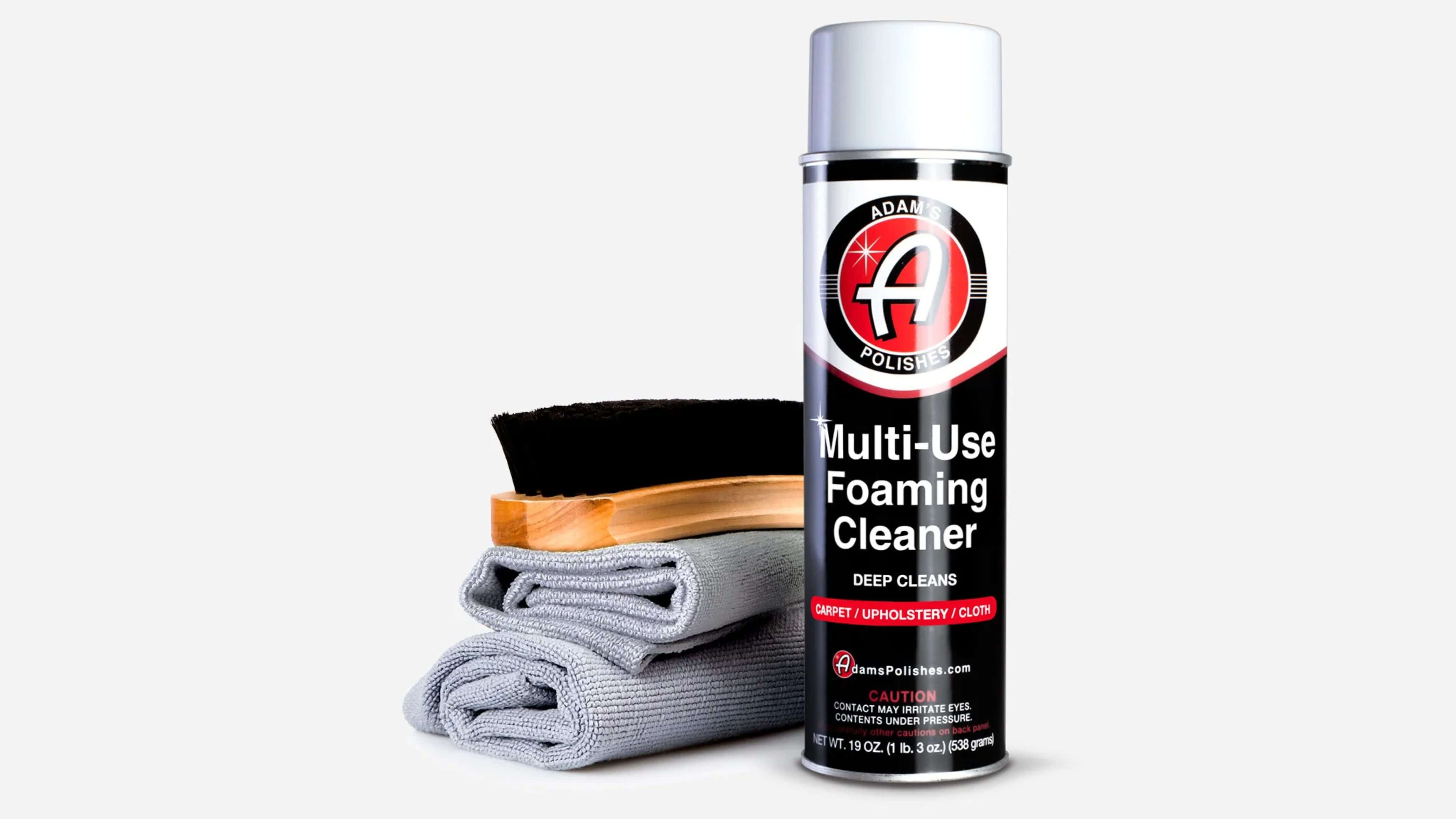 Adam's Polishes Multi-Use Foaming Cleaner with cloth and brush for car interior cleaning.