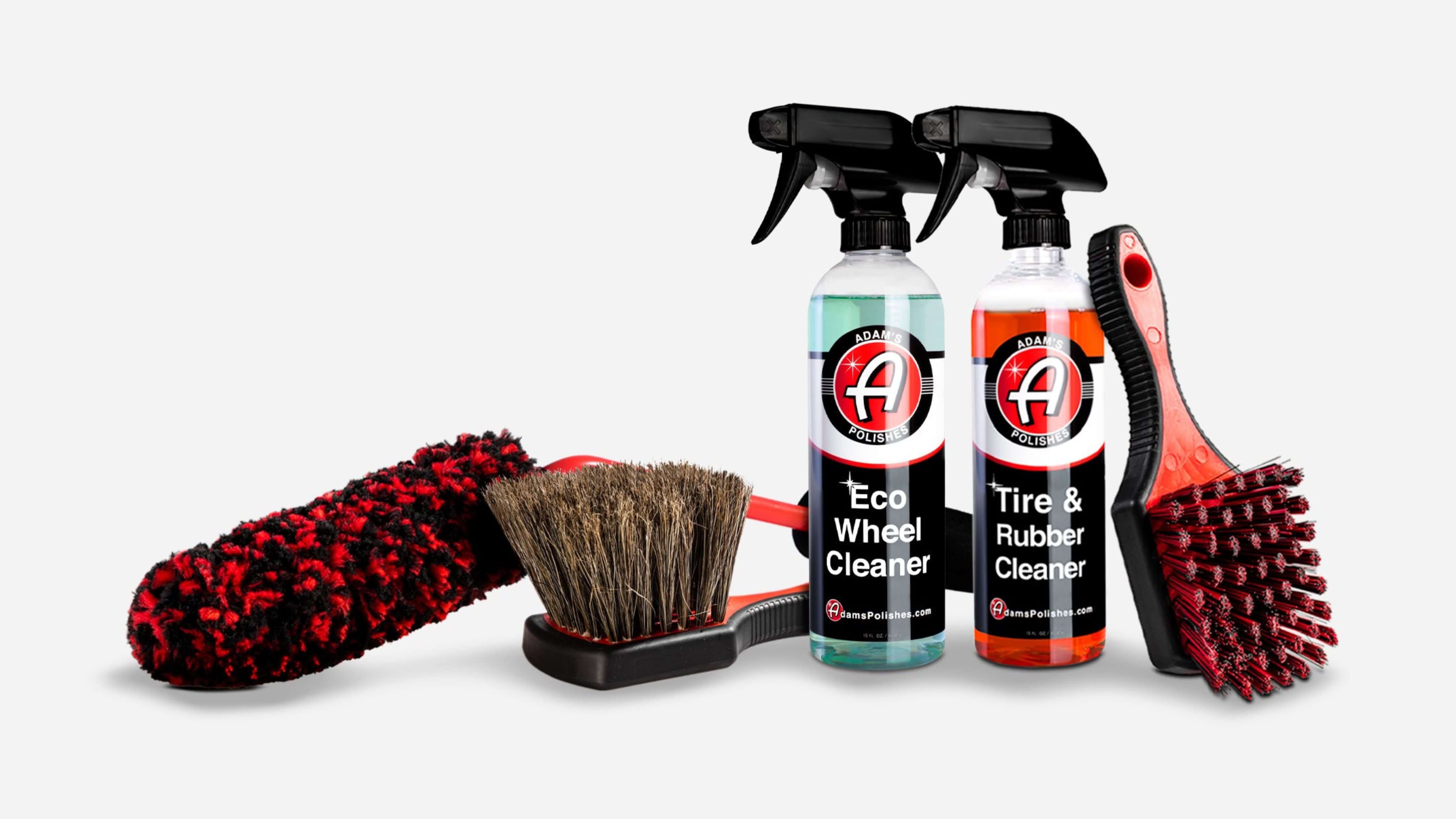 Car detailing kit with spray bottles and brushes for interior cleaning.