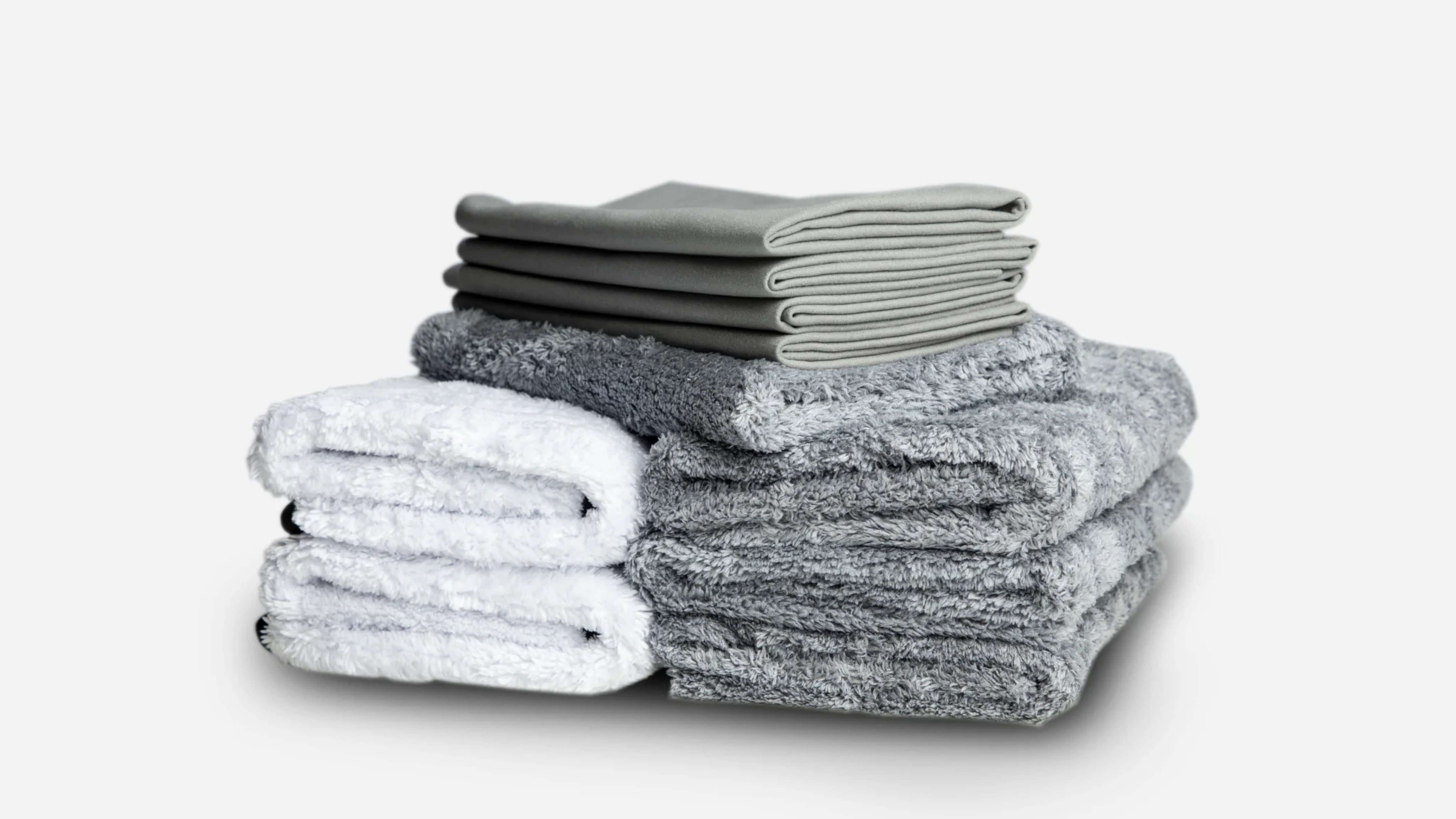 Gray and white microfiber towels ideal for car enthusiasts' detailing needs.