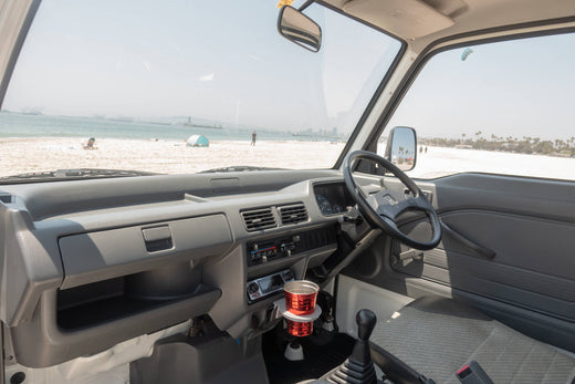 Interior View of a Honda Acty Kei Truck Parked on a Beach with Ocean View"