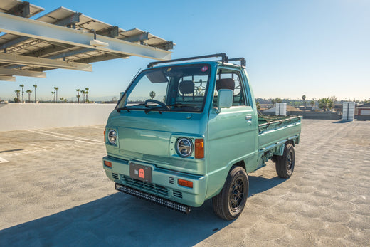 Japanese import car driving on California coastal highway, ready for registration after meeting JDM legalization requirements