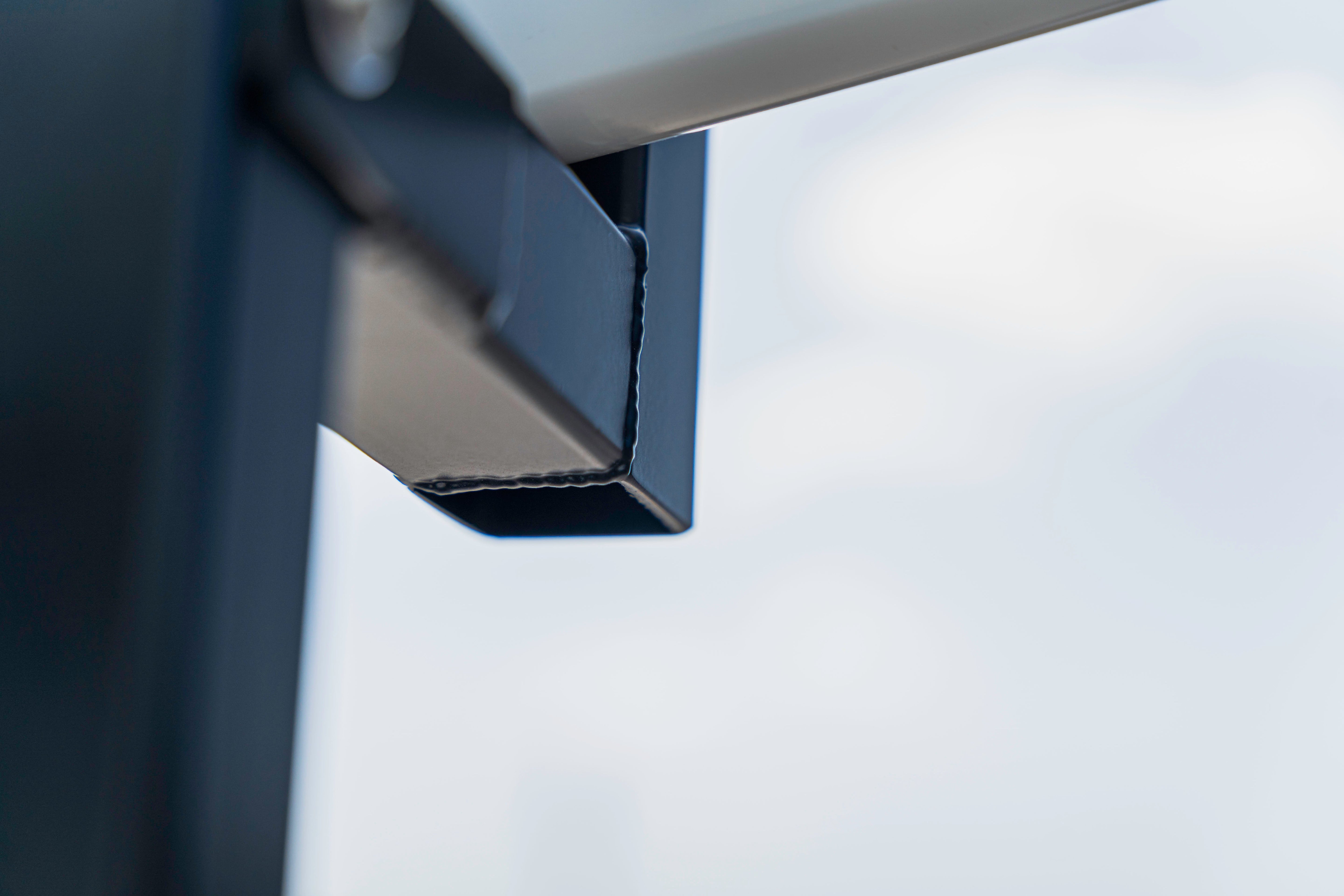 Close-up of a metal bracket or hinge with a blurred background.