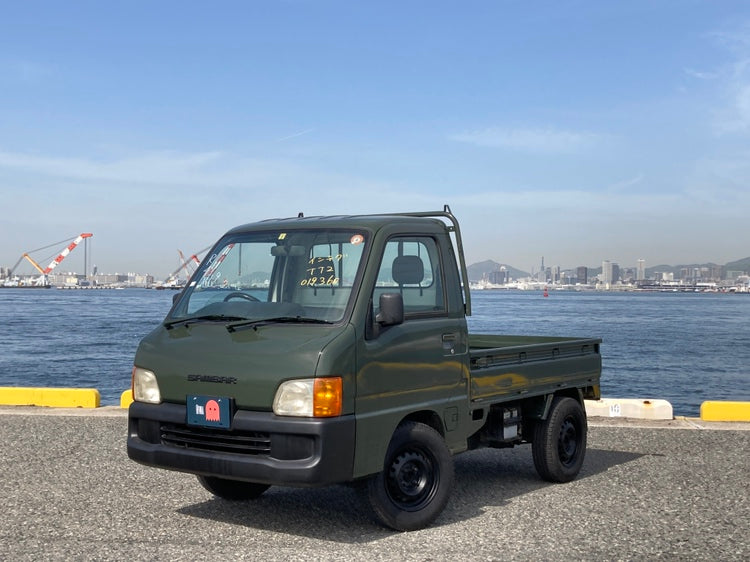 Subaru Sambar kei truck in military green, featuring rugged design and compact size, perfect for Utah's outdoor adventures, imported by Oiwa Garage.