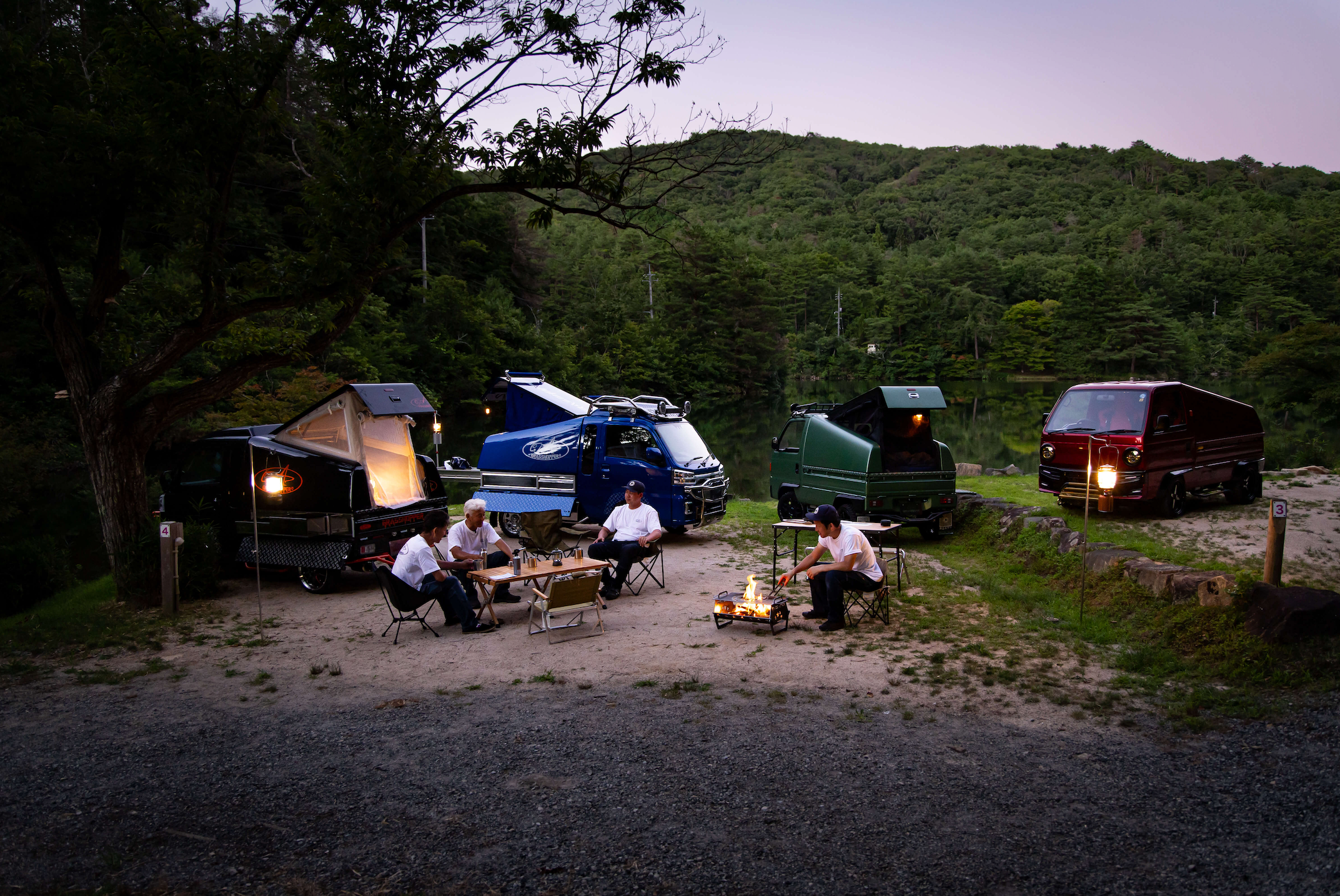 Group of Custom Kei Truck Campers Gathered at a Campsite - Exploring the Off-Road Capabilities and Versatility of 4x4 Kei Trucks, Perfect for Adventurers.