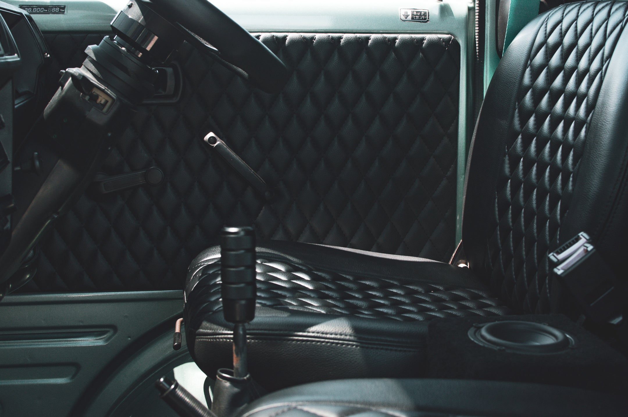 Custom Suzuki Carry mini truck on a scenic road, highlighting its compact design and versatility for small businesses.
