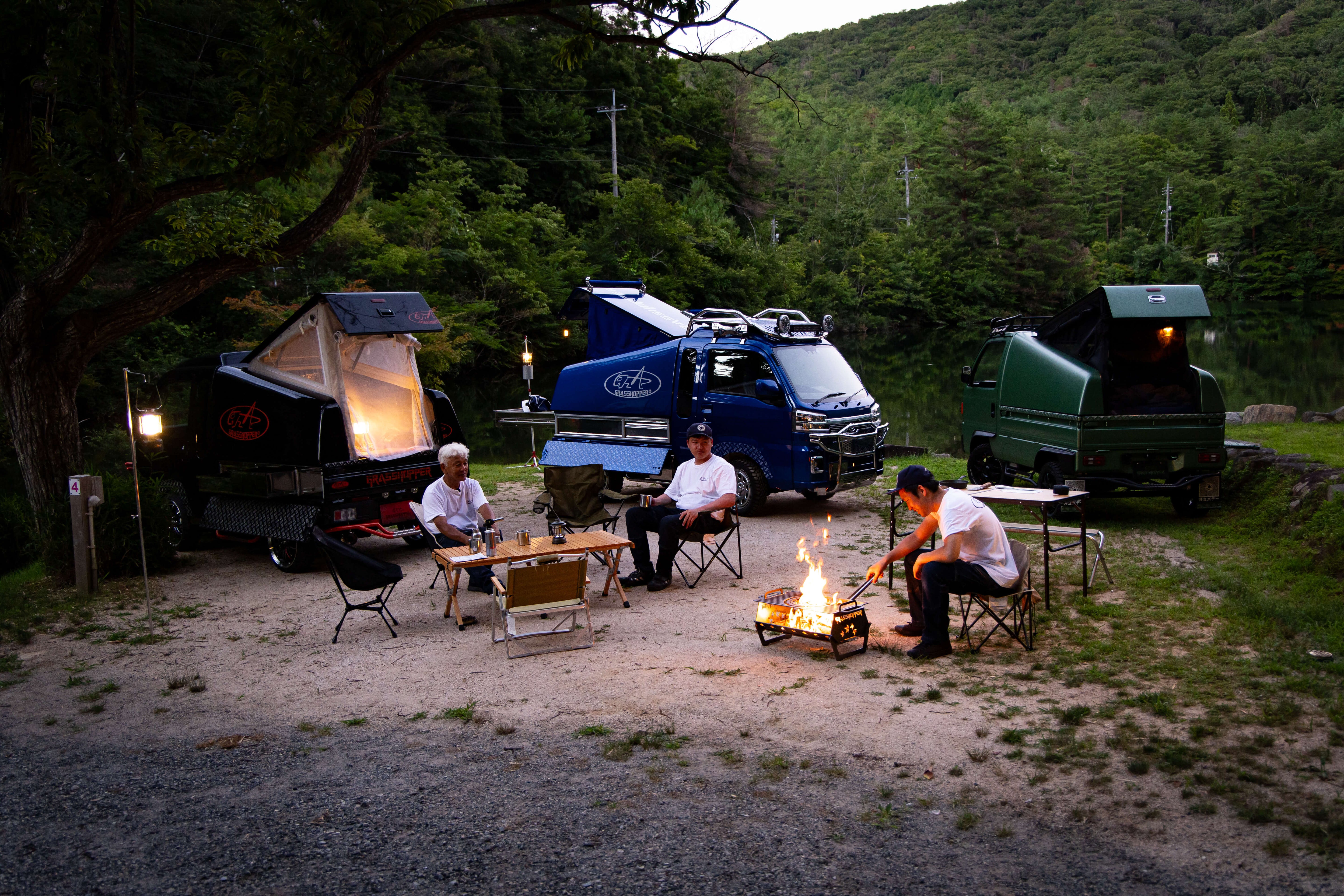 A vibrant Honda Acty Kei Truck standing in a scenic Japanese landscape, showcasing its compact design and versatility.