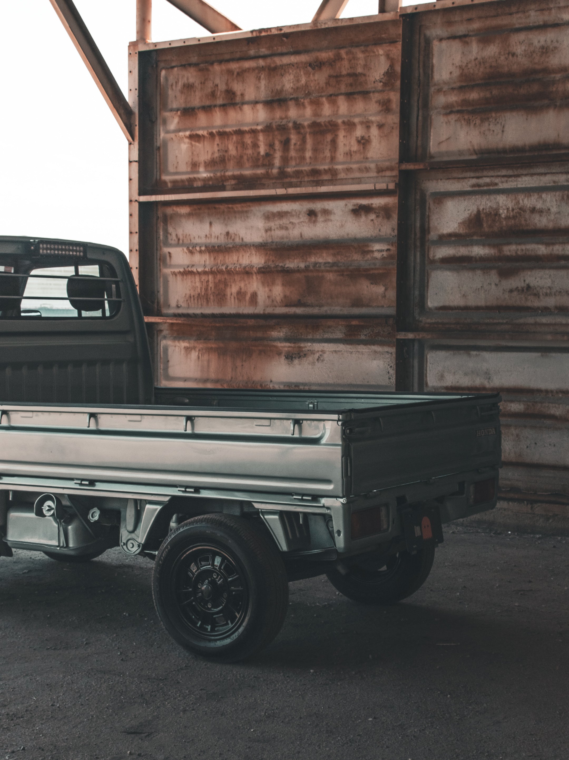 Vintage kei truck driving through scenic Washington State landscape