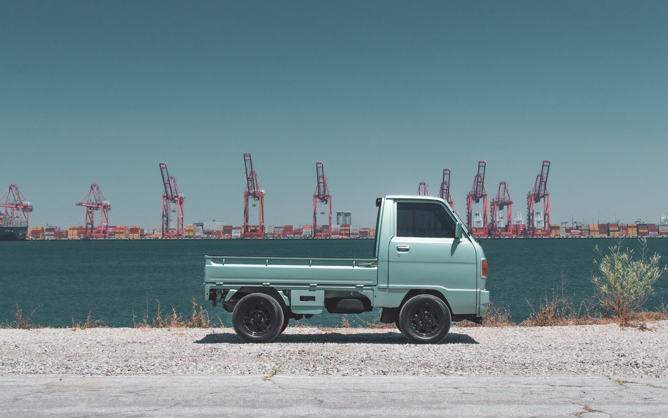 Kei truck in California street, showcasing its compact size and charm.