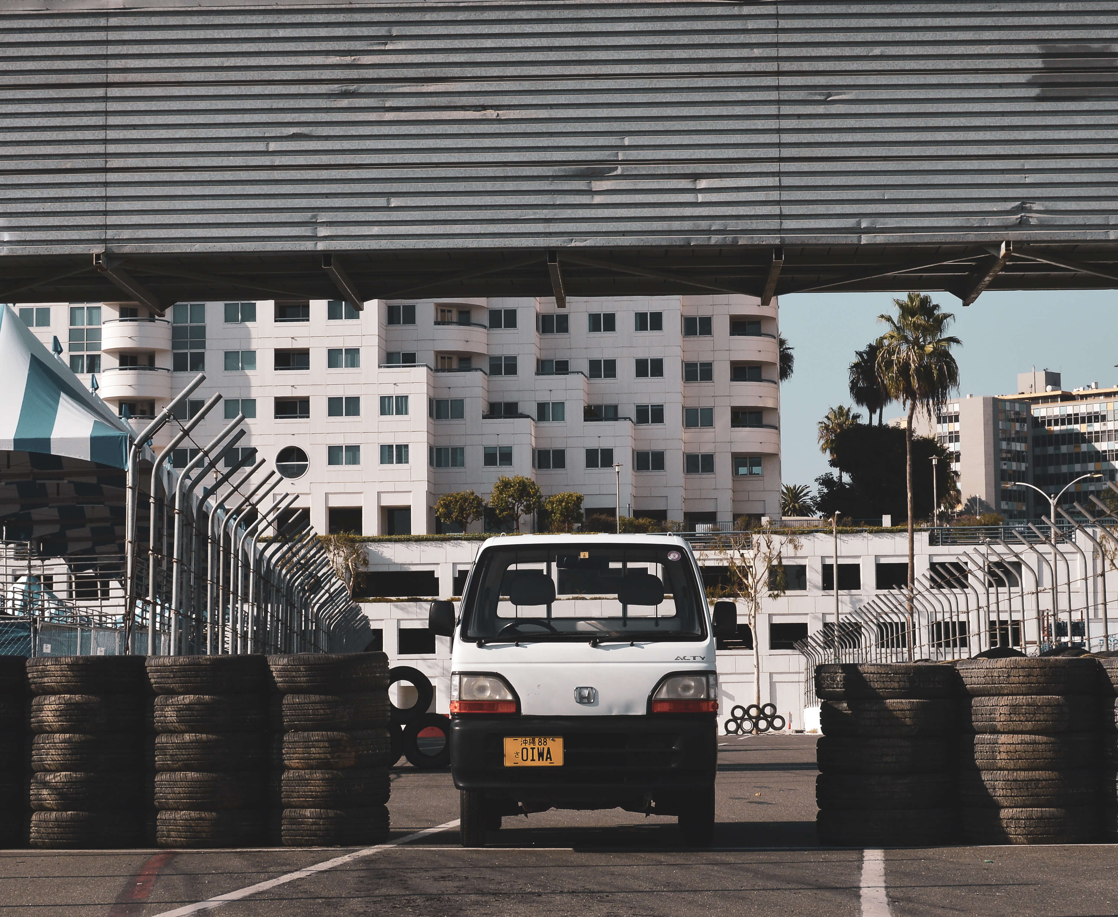 A kei truck speeding down a city street, showcasing its top speed capabilities.