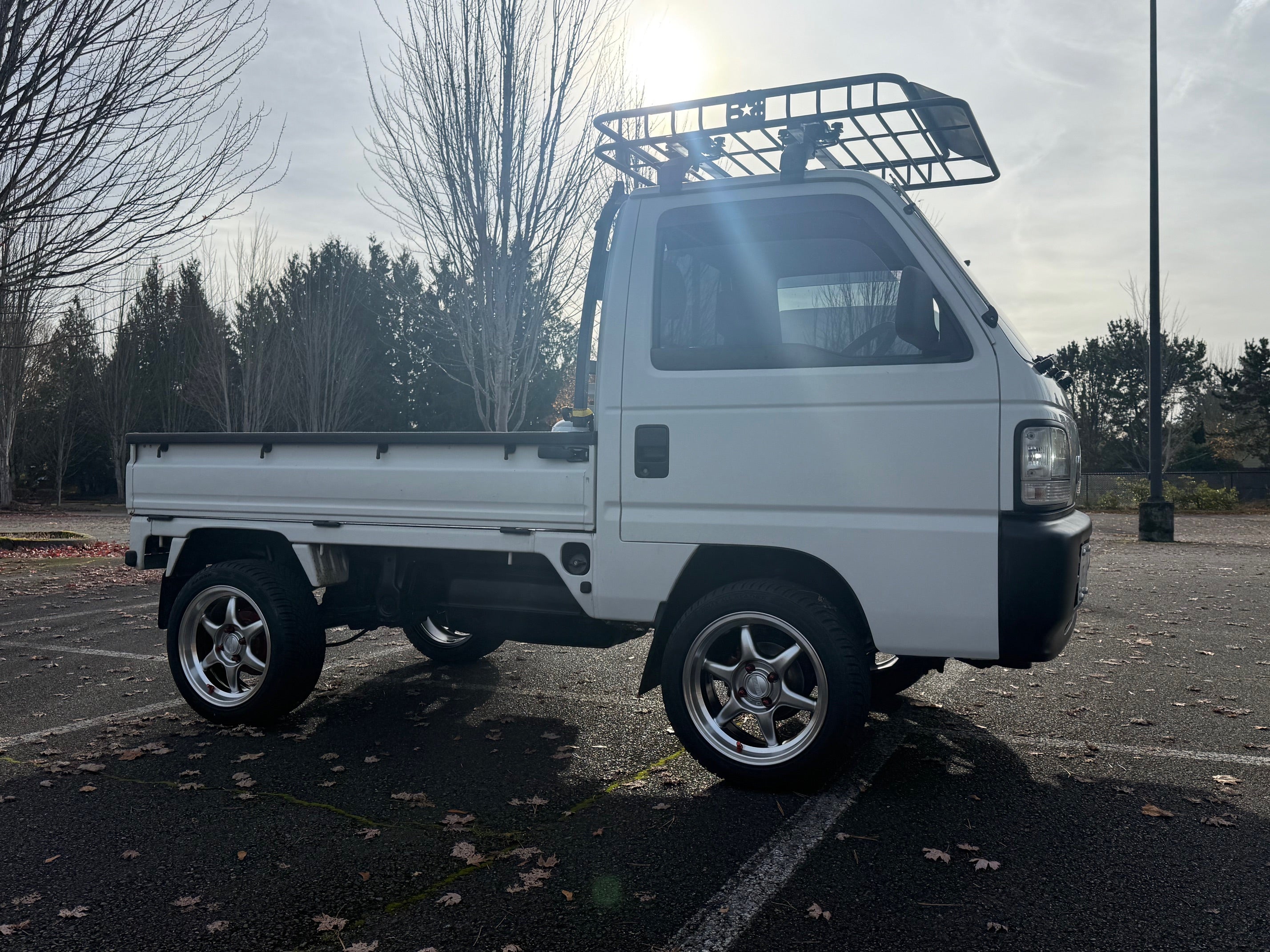 Side view of a 1997 Honda Acty serving as a daily driver and business vehicle 