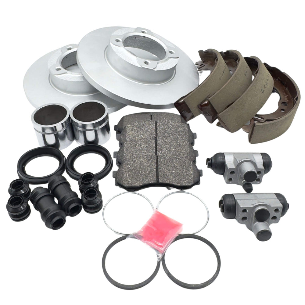 Brake Kit - 27 Piece for Daihatsu Hijet and Atrai models (1994-1998) featuring front and rear pads, rotors, caliper pistons, seal kit, brake shoes, and drum brake wheel cylinders.