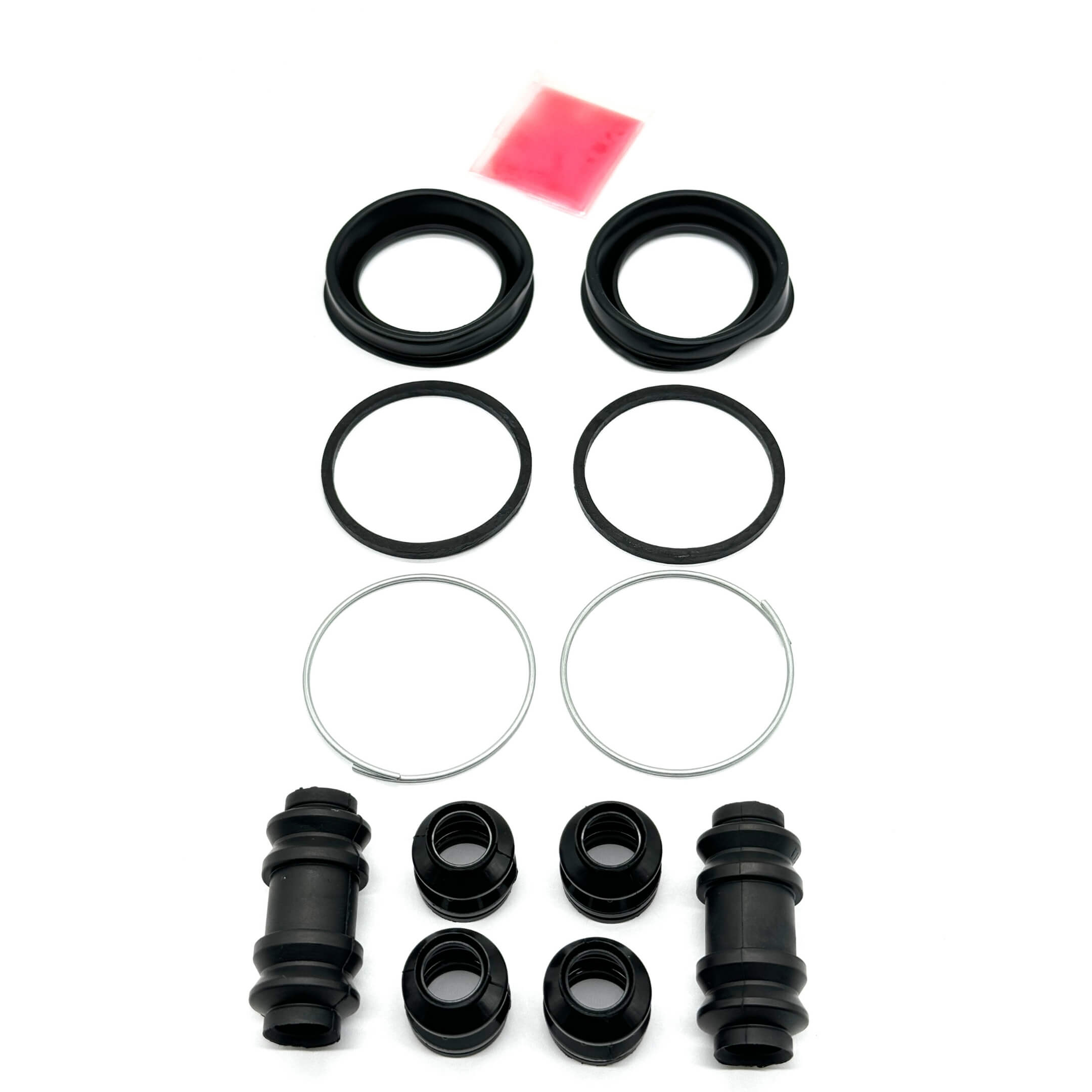 Front brake caliper seal kit for Daihatsu Hijet S100P and S110P models (1994-1999), including seals, boots, and grease for optimal braking performance and maintenance.