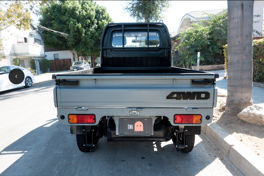 Rear view of Suzuki Carry DC51T DD51T 1991-1998 showcasing exterior body components including tailgate, taillights, and 4WD badge