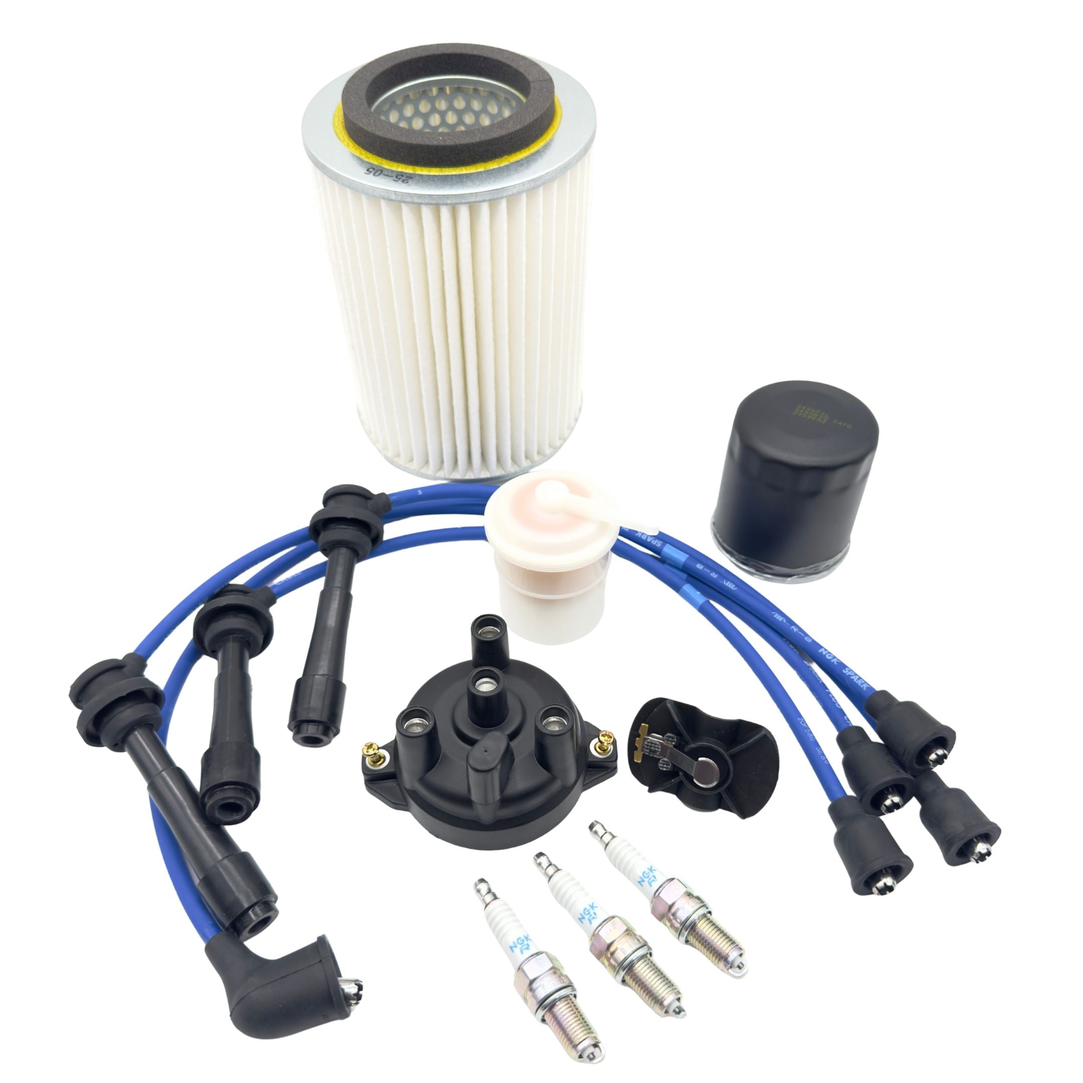 Twelve piece ignition kit for Suzuki Carry DC51T and DD51T 1991 to 1999, showing distributor cap, rotor, NGK spark plugs, blue spark plug wires, large air filter, fuel filter, and oil filter arranged on a white background for a complete tune up package.