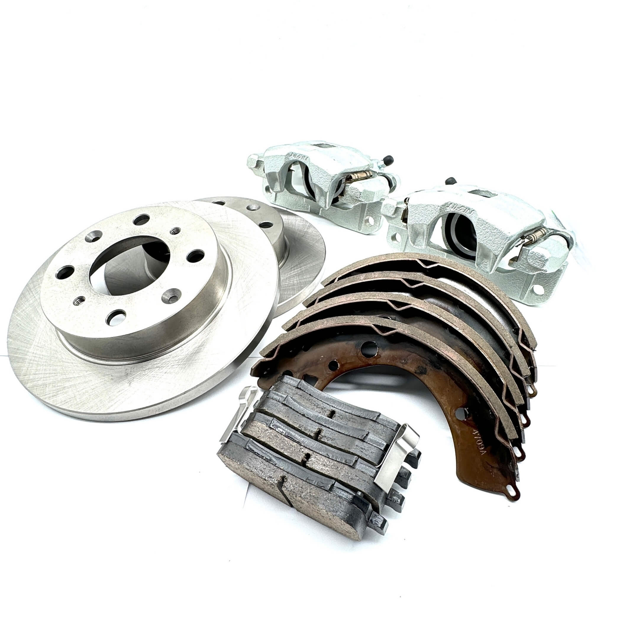 Brake Package - 4 Piece set for Honda Vamos Van HM1, HM2 models (1999-2018) featuring silver front brake pads, rotors, rear brake shoe set, and calipers.