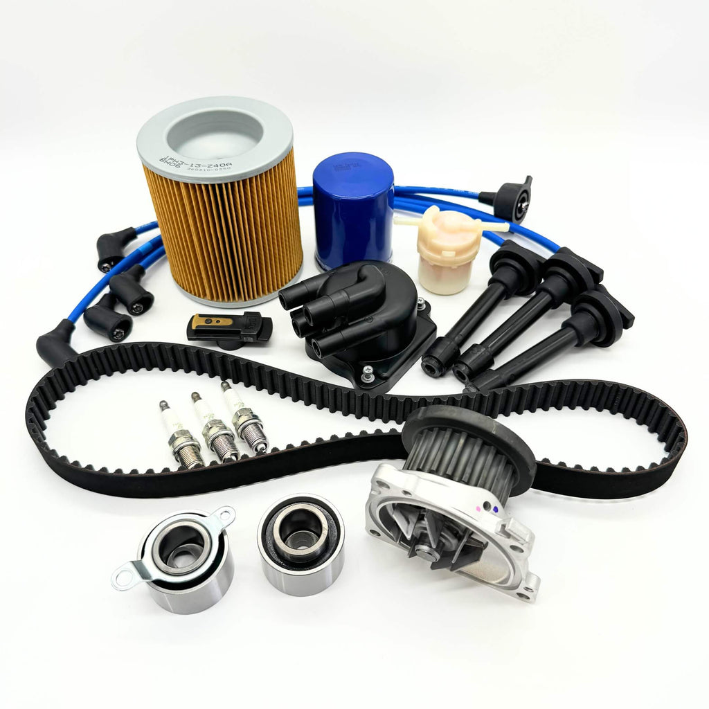 14-piece Mega Timing Belt and Tune-Up Kit for Honda Acty HA3/HA4 1990-1999, featuring an air filter, fuel filter, oil filter, distributor cap and rotor, spark plugs and wires, and a premium timing belt, all displayed on a white background, available with free shipping from Oiwa Garage.