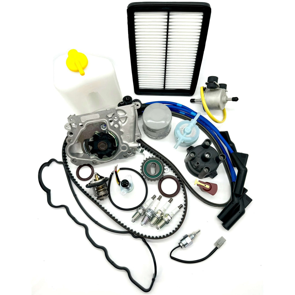 Subaru Sambar KS3 KS4 1990-1998 complete 25-piece timing belt kit, featuring durable timing belt, tensioner, seals, water pump, belts, thermostat, gasket, filters, spark plugs, ignition system components, coolant tank, carburetor valves, and fuel pump for a full engine tune-up and performance upgrade.