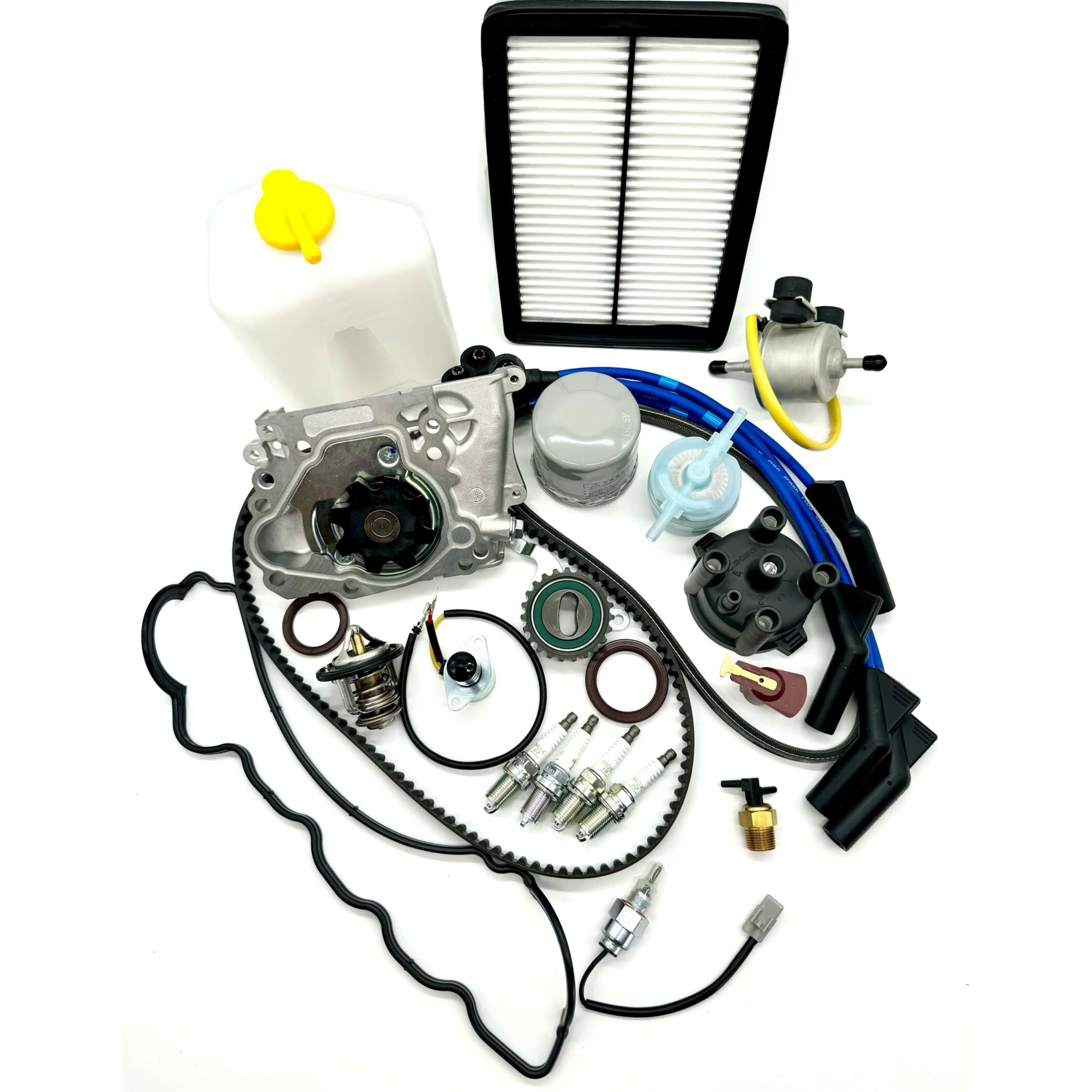 Subaru Sambar KV3 KV4 1990-1998 full 26-piece timing belt maintenance kit with essential engine parts including timing belt, tensioner, seals, water pump, alternator belt, thermostat, gaskets, filters, spark plugs, ignition system components, coolant tank, carburetor valves, fuel pump, and 2-prong thermo valve assembly.