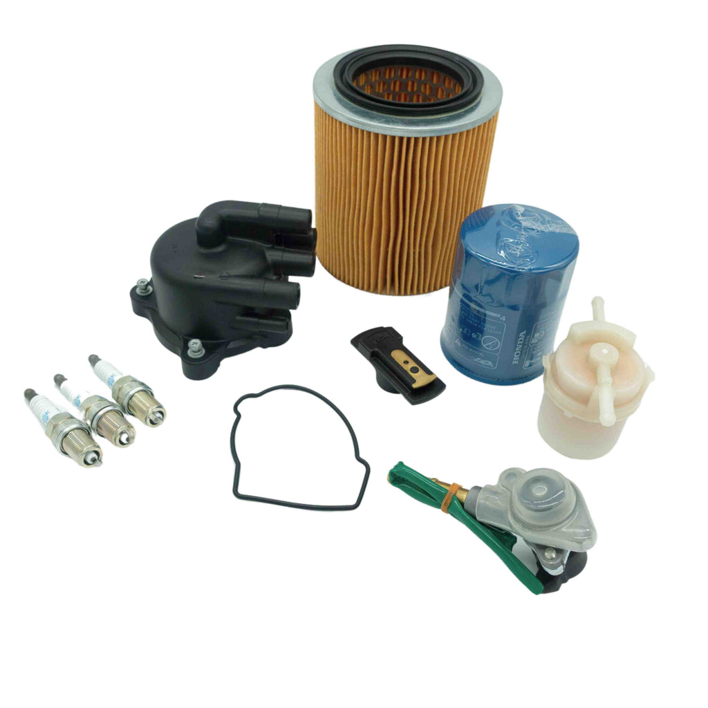 Honda Acty 1990-1999 11-Piece Tune-Up Kit including distributor cap, rotor, gasket, spark plugs, filters, and air solenoid.
