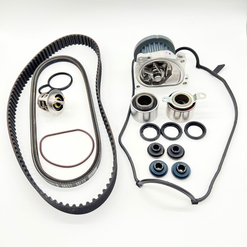 Honda Acty HA3 HA4 9-Piece Timing Belt Kit, featuring a ribbed belt, water pump, thermostat, tensioner and idler pulleys, cam and crank seals, and valve cover gasket, designed for 1990-1999 models.