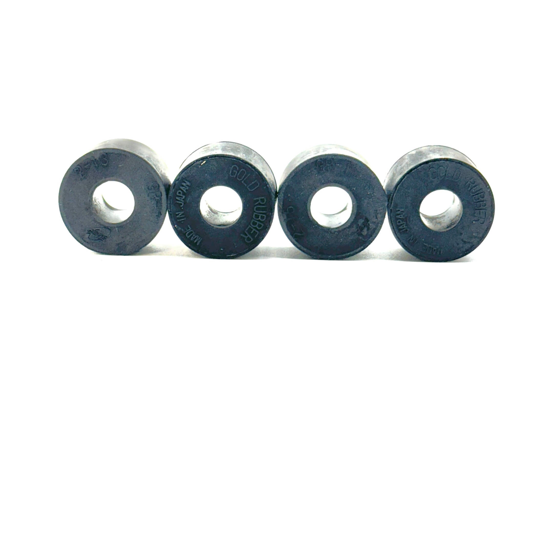 Close-up view of four black Rear Shock Absorber Grommets, made of high-quality rubber for Honda Acty HA3 and HA4 models (1990-1999).