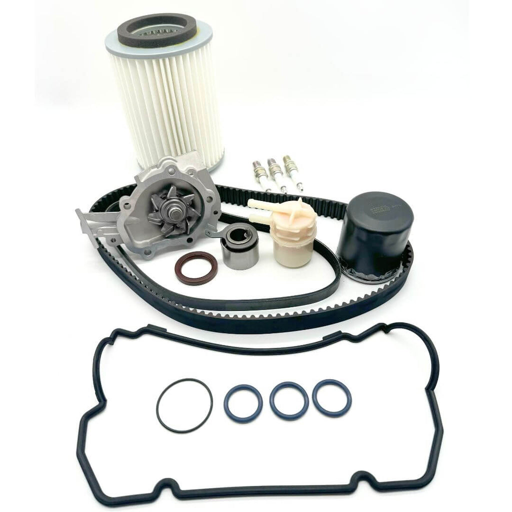 16-piece Timing Belt Kit for Suzuki Carry DC51T and DD51T (1991-1998), including timing belt, alternator belt, water pump, pulley, cam seal, valve cover gasket, filters, and spark plugs. Comprehensive solution for engine repair and maintenance