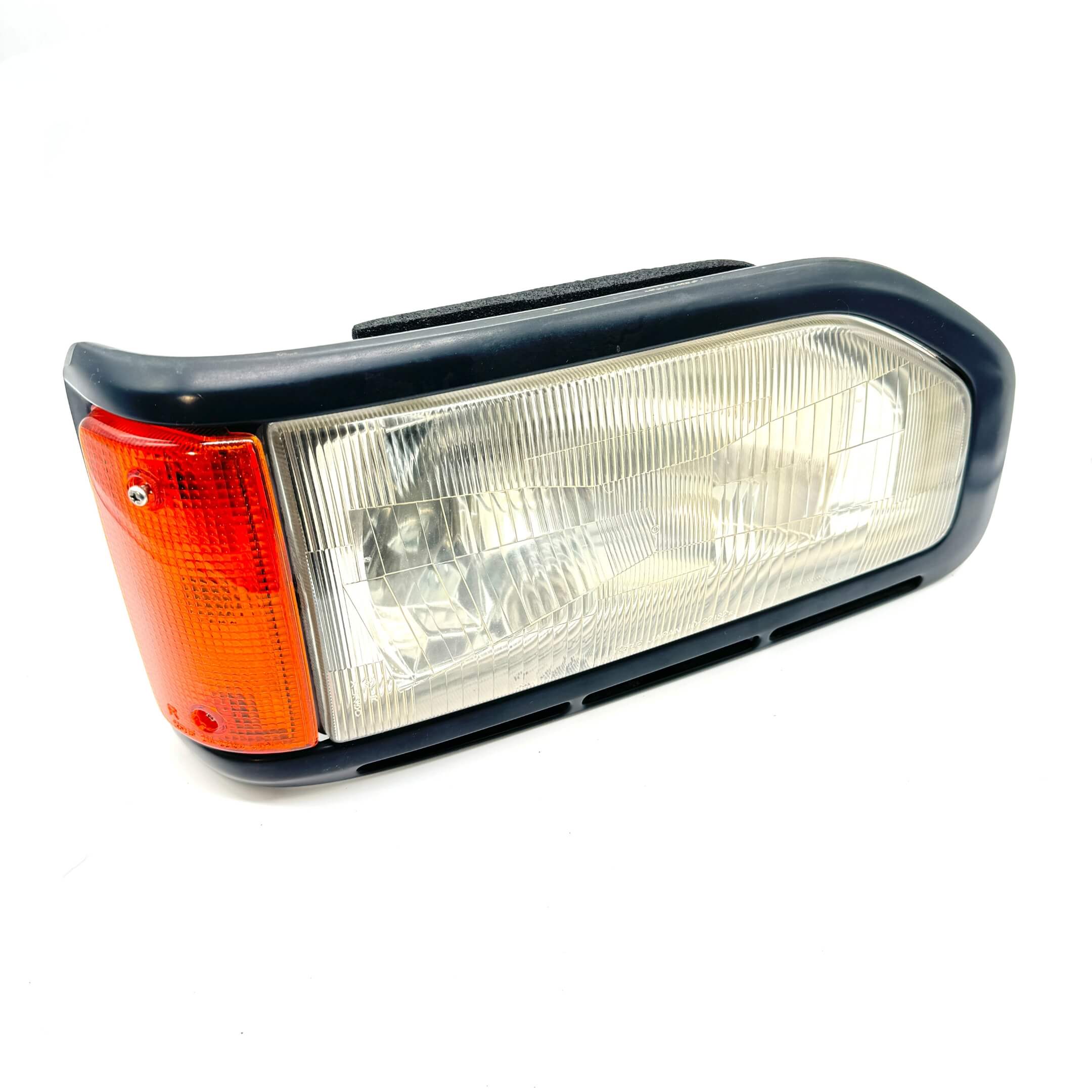 Right headlight assembly for Honda Acty Truck HA3, HA4 models 1990-1993 with clear lens and orange indicator.