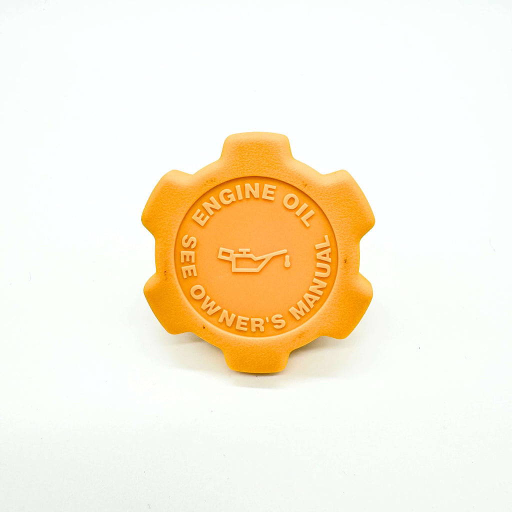 Orange engine oil cap with embossed instructions for Subaru Sambar KS3, KS4 models, compatible with 1990-1998, ensuring secure sealing and easy manual reference