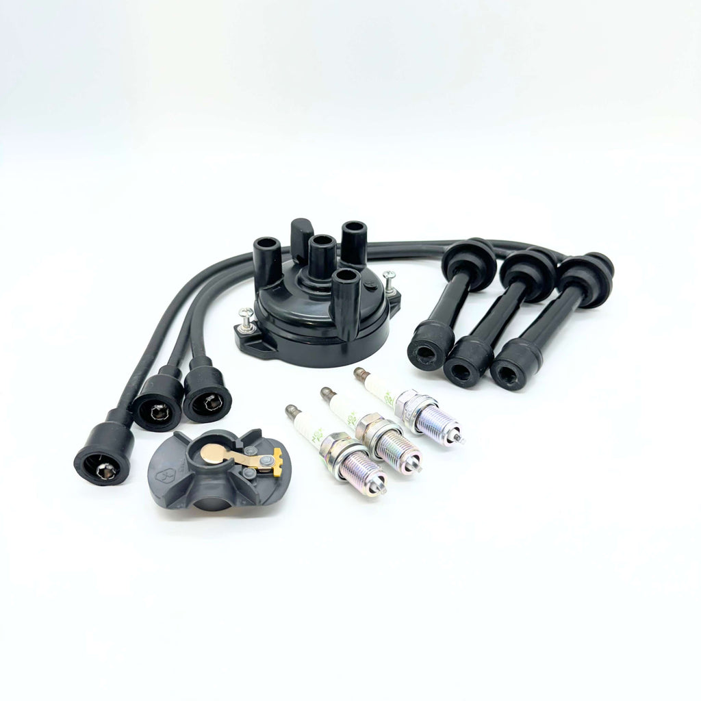 Extensive 8-Piece Ignition Kit for Suzuki Carry Truck DC51T, DD51T models (1991-1998), showcasing a high-quality black distributor cap, durable rotor, four precision spark plugs, and a set of heavy-duty spark plug wires for reliable engine performance