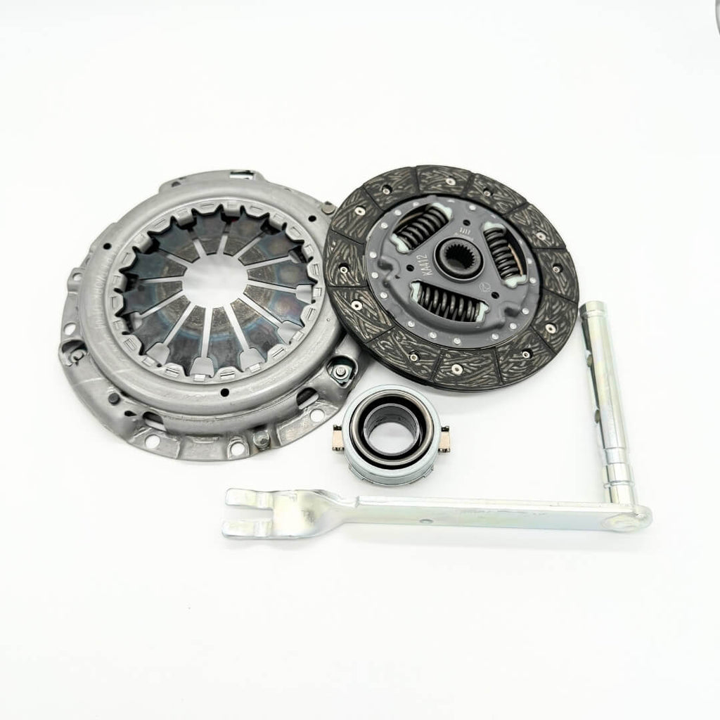 Comprehensive 4-piece clutch replacement kit for 1990-1998 Subaru Sambar KS3, KS4 models, including clutch disc, pressure plate, release bearing, and release lever, available at Oiwa Garage.