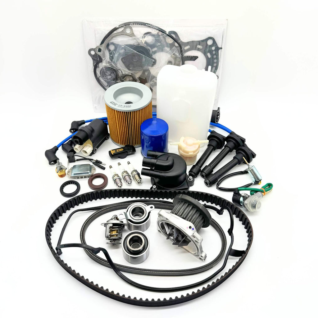 Complete 24-piece Mega Timing Belt and Tune Up Kit for 1990-1999 Honda Acty HA3/HA4, featuring OEM-quality air filter, fuel filter, oil filter, distributor cap and rotor, high-efficiency spark plugs with wires, ignition control module with coil sensor, ignition assembly, engine gasket set, timing and alternator belts, coolant reserve tank, air thermal valve, all displayed on a white background, exclusively available at Oiwa Garage with free shipping.