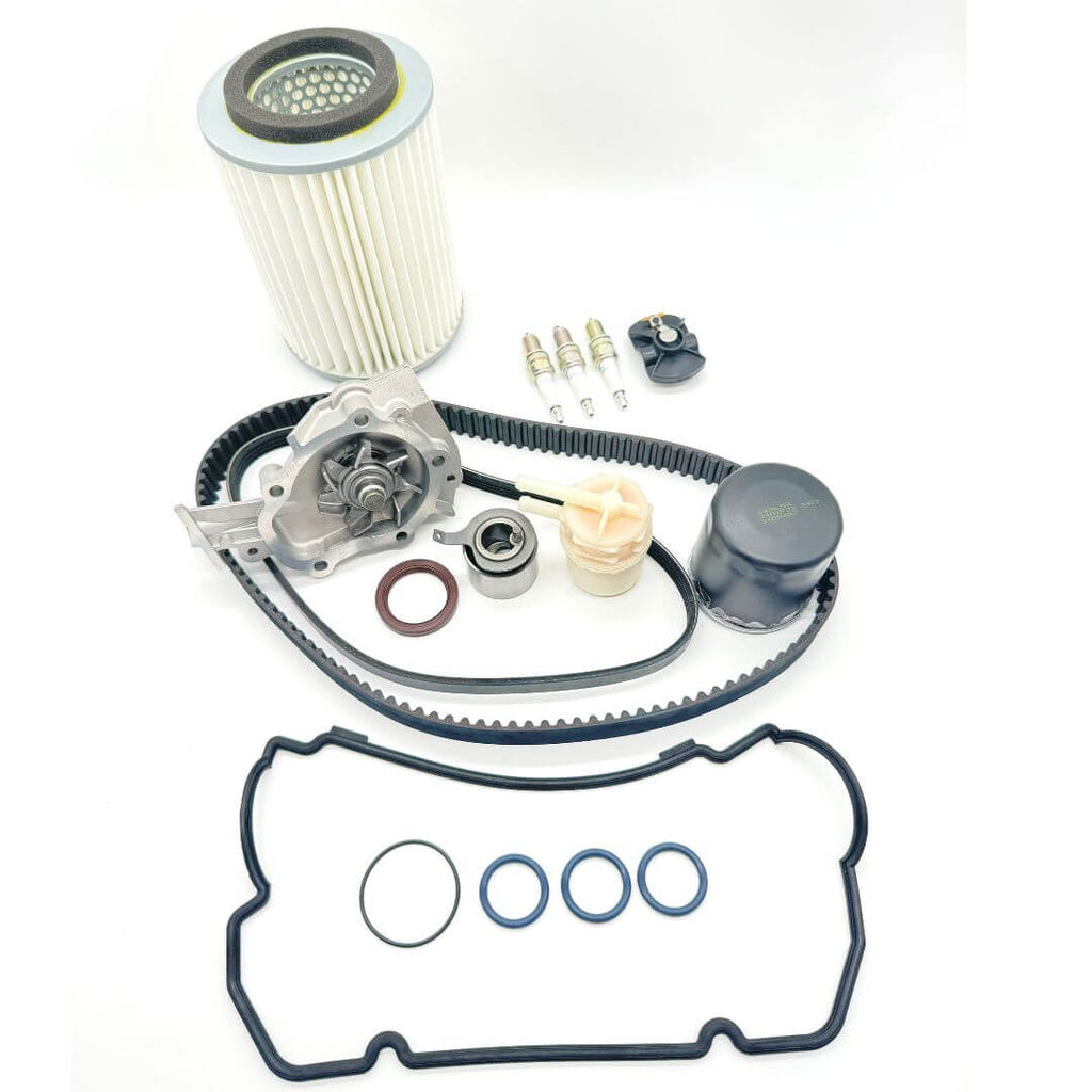17-piece Timing Belt Kit for Suzuki Carry DC51T and DD51T (1991-1998), including timing belt, alternator belt, water pump, pulley, cam seal, valve cover gasket, filters, spark plugs, and distributor rotor. Comprehensive solution for engine repair and maintenance.