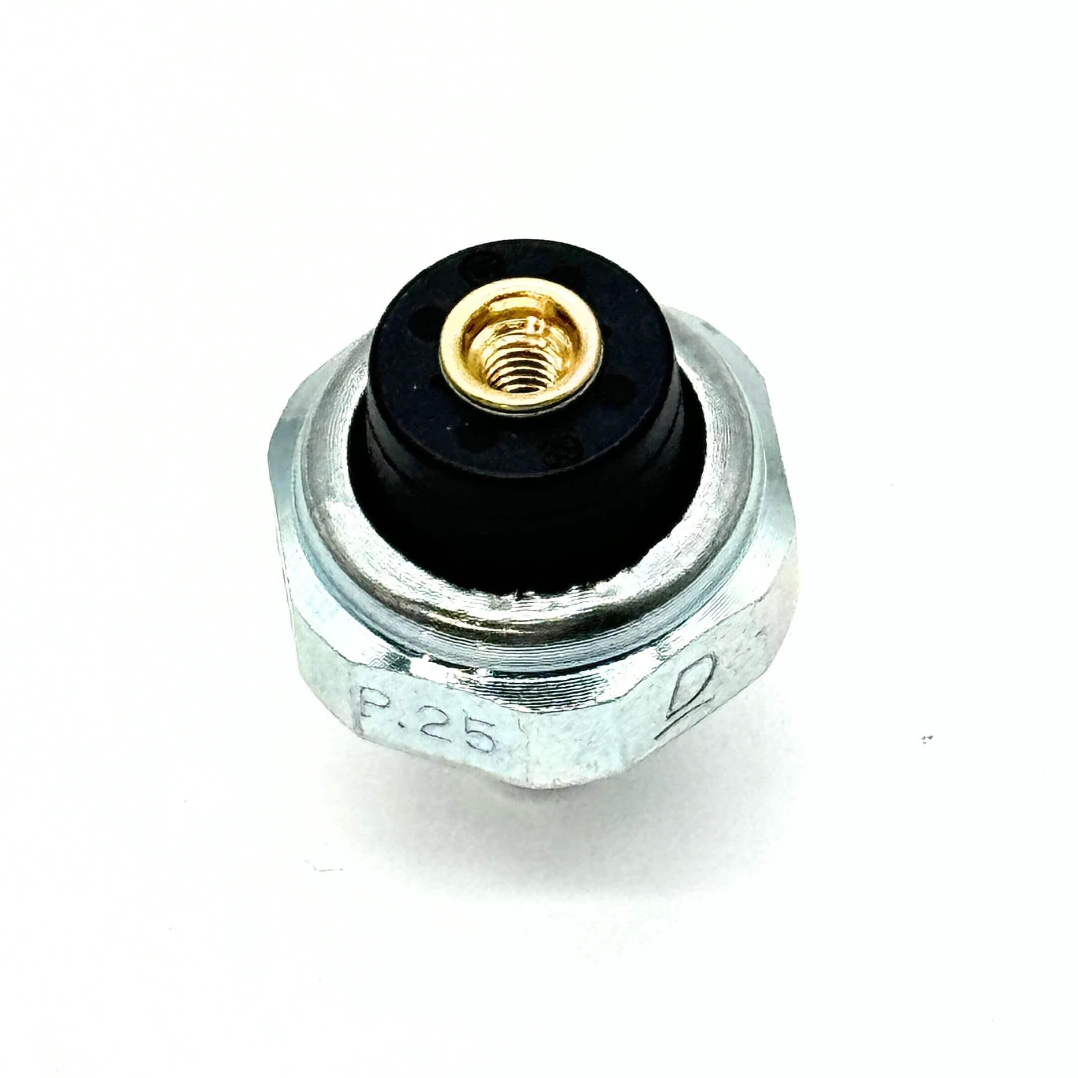 Top view of the Honda Acty Oil Pressure Switch featuring black rubber seal and brass connector.