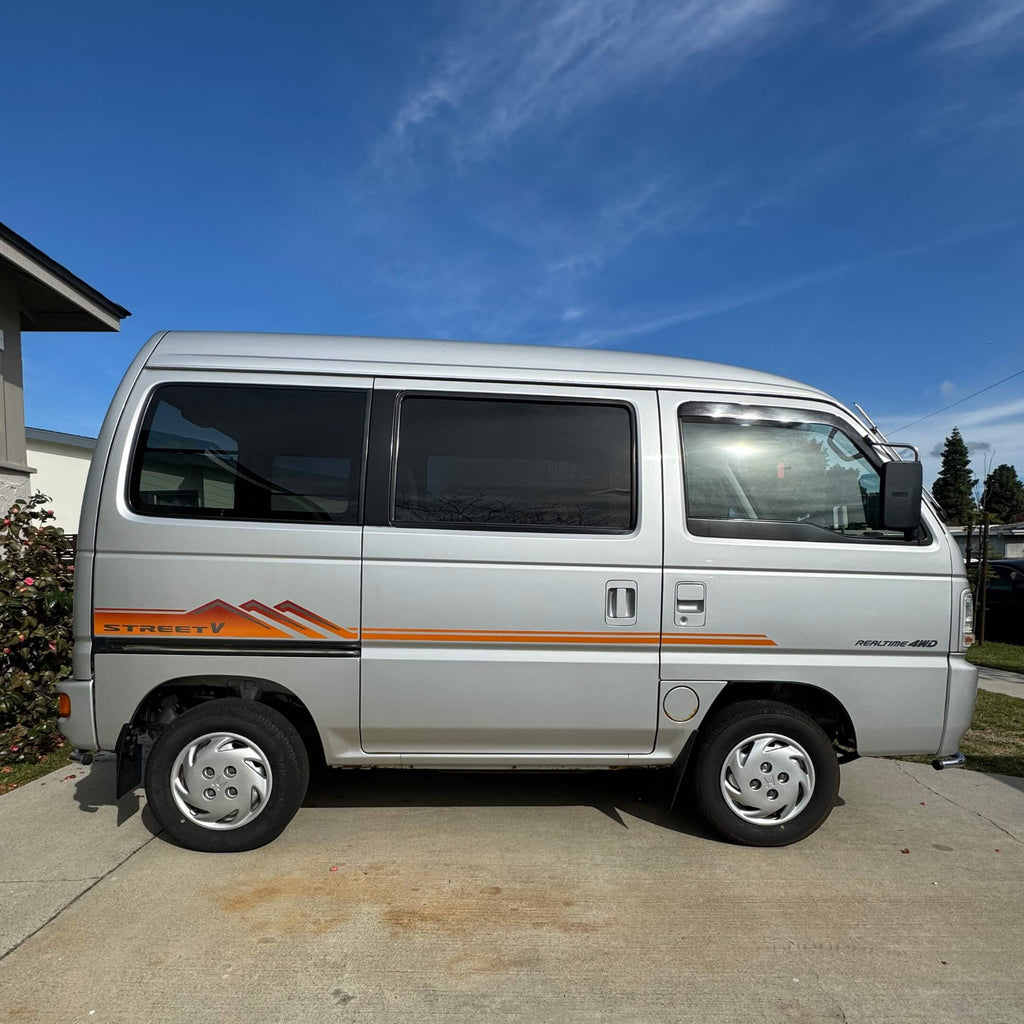 Full side profile of Honda Street Van HH4 with a detailed view of the orange Street V side decal, reflecting the unique style of 1990s Japanese kei vans