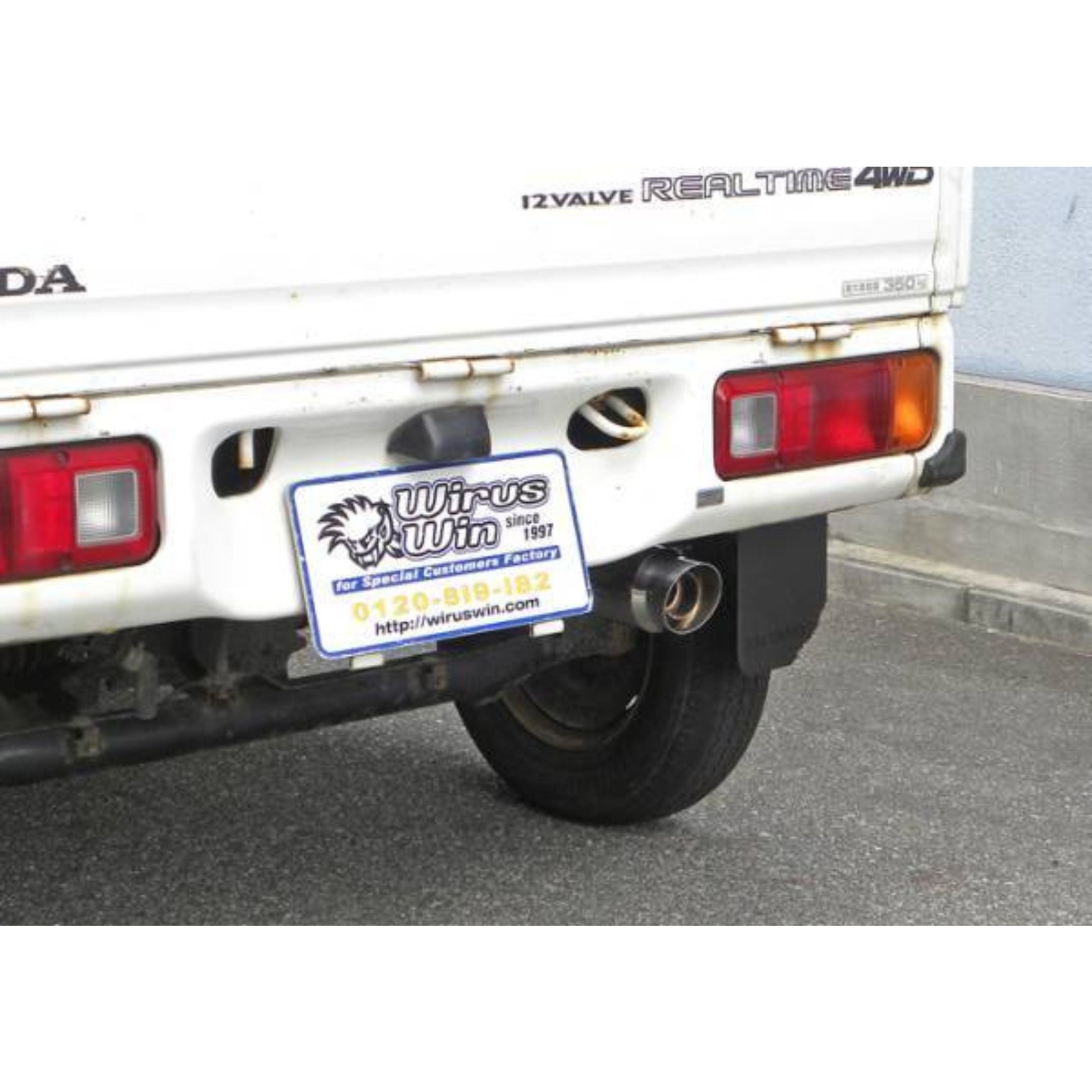 Custom-fit Wirus Win Stainless Steel Exhaust Muffler mounted on a Honda Acty Truck HA3, HA4 (1990-1999), showcasing the right-side outlet position and sleek rear customization design.