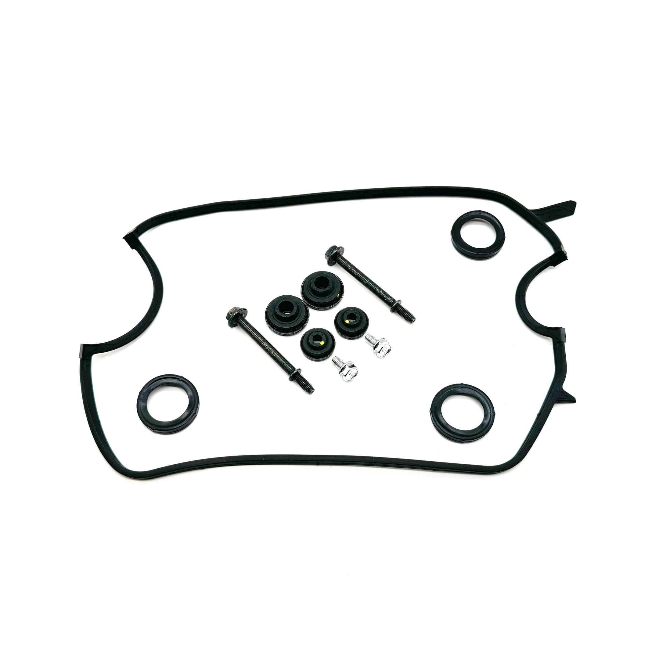 "Set of bolts and seals alongside a valve cover gasket designed for Honda Acty Truck HA3, HA4 - viewed from above on a white surface.