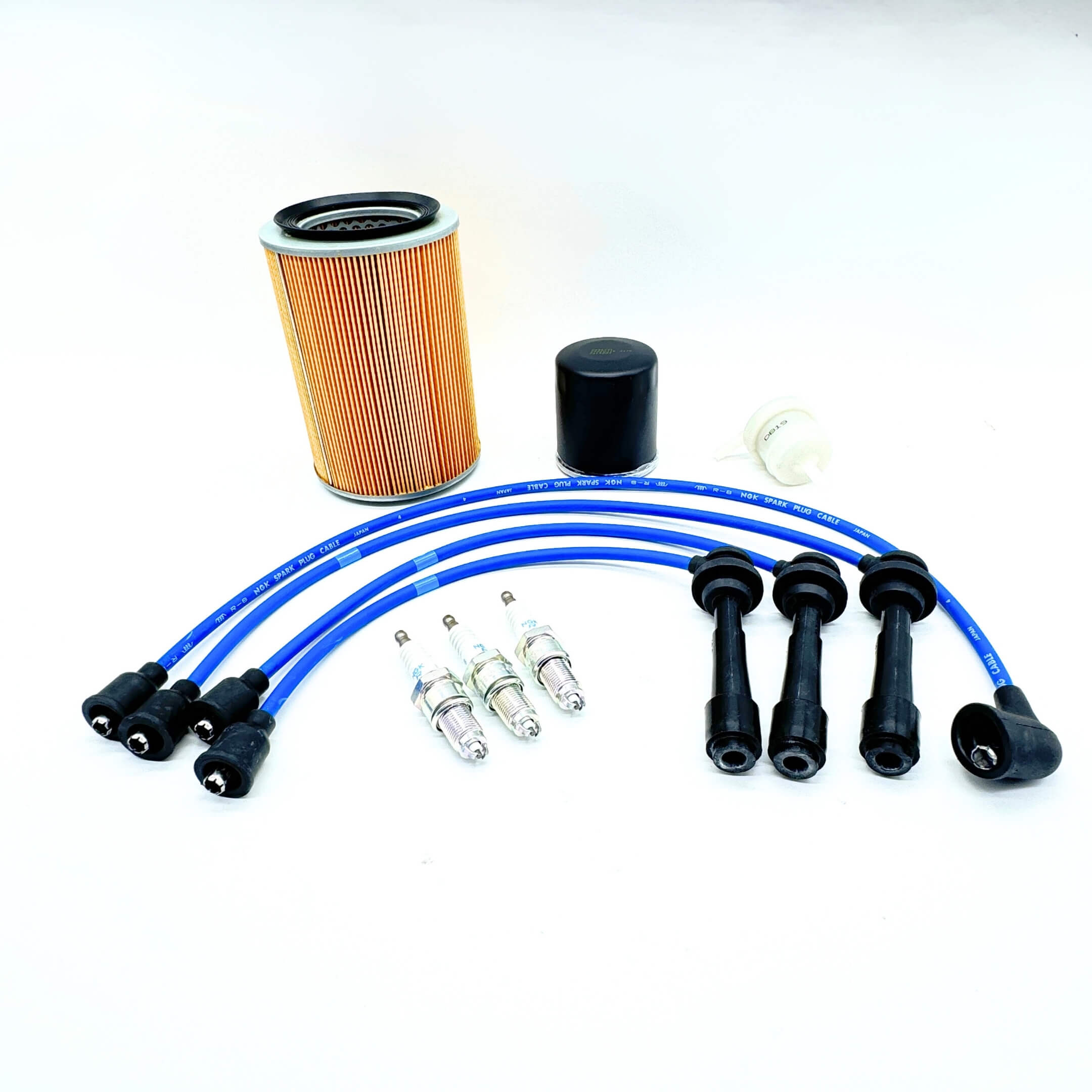 Daihatsu Hijet 10 Piece Maintenance Kit - Close-Up of Air Filter, Fuel Filter, Oil Filter, NGK Spark Plugs, and Blue Spark Plug Wires for EF-NS Engines