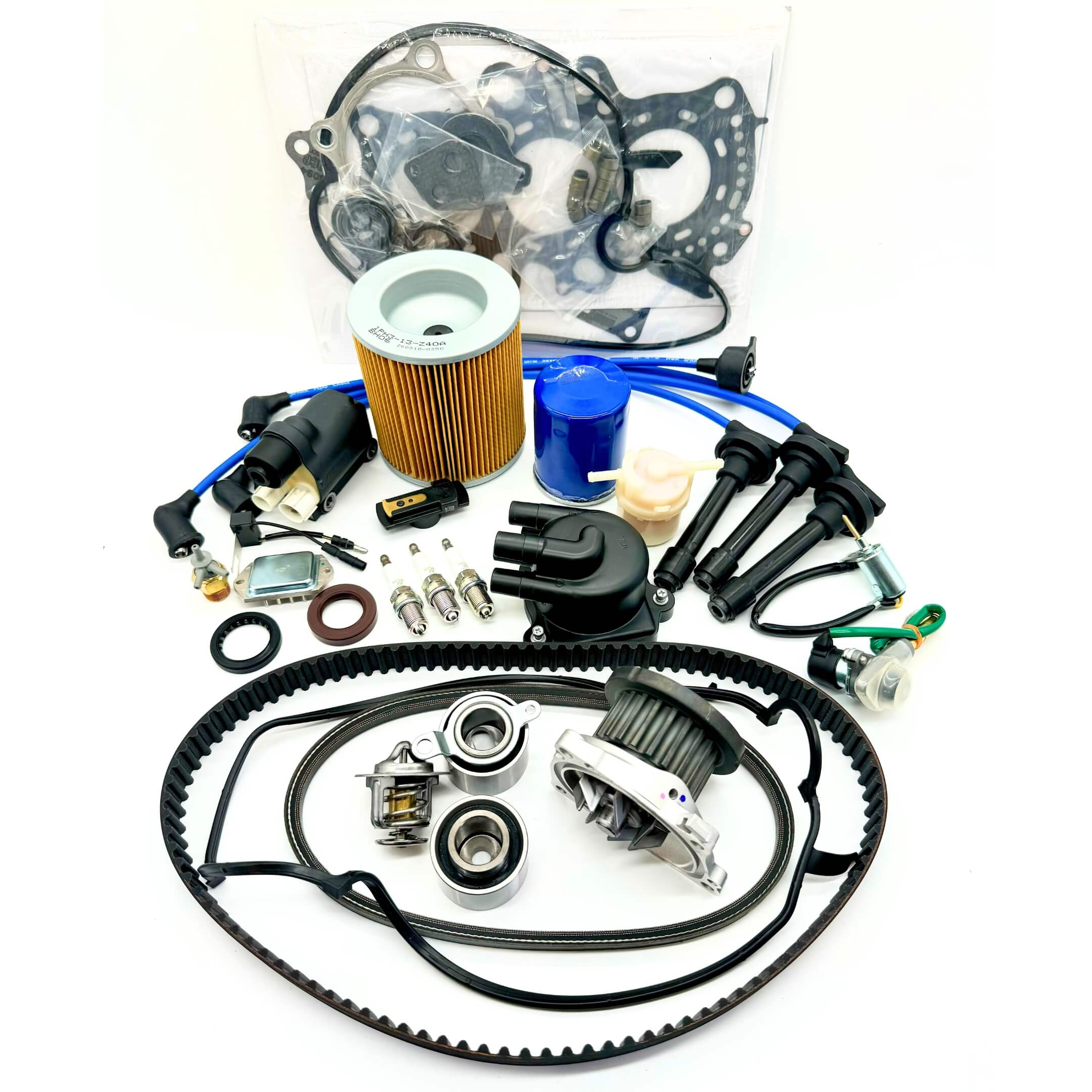 23-piece Mega Timing Belt and Tune-Up Kit for 1998  Honda Acty HA3/HA4 showcased on a white background, including high-quality air and fuel filters, oil filter, distributor cap and rotor, spark plugs with wires, ignition control module with coil sensor, ignition assembly, complete engine gasket set, timing and alternator belts, and air thermal valve, available at Oiwa Garage with free shipping, ideal for vehicle maintenance and engine optimization.