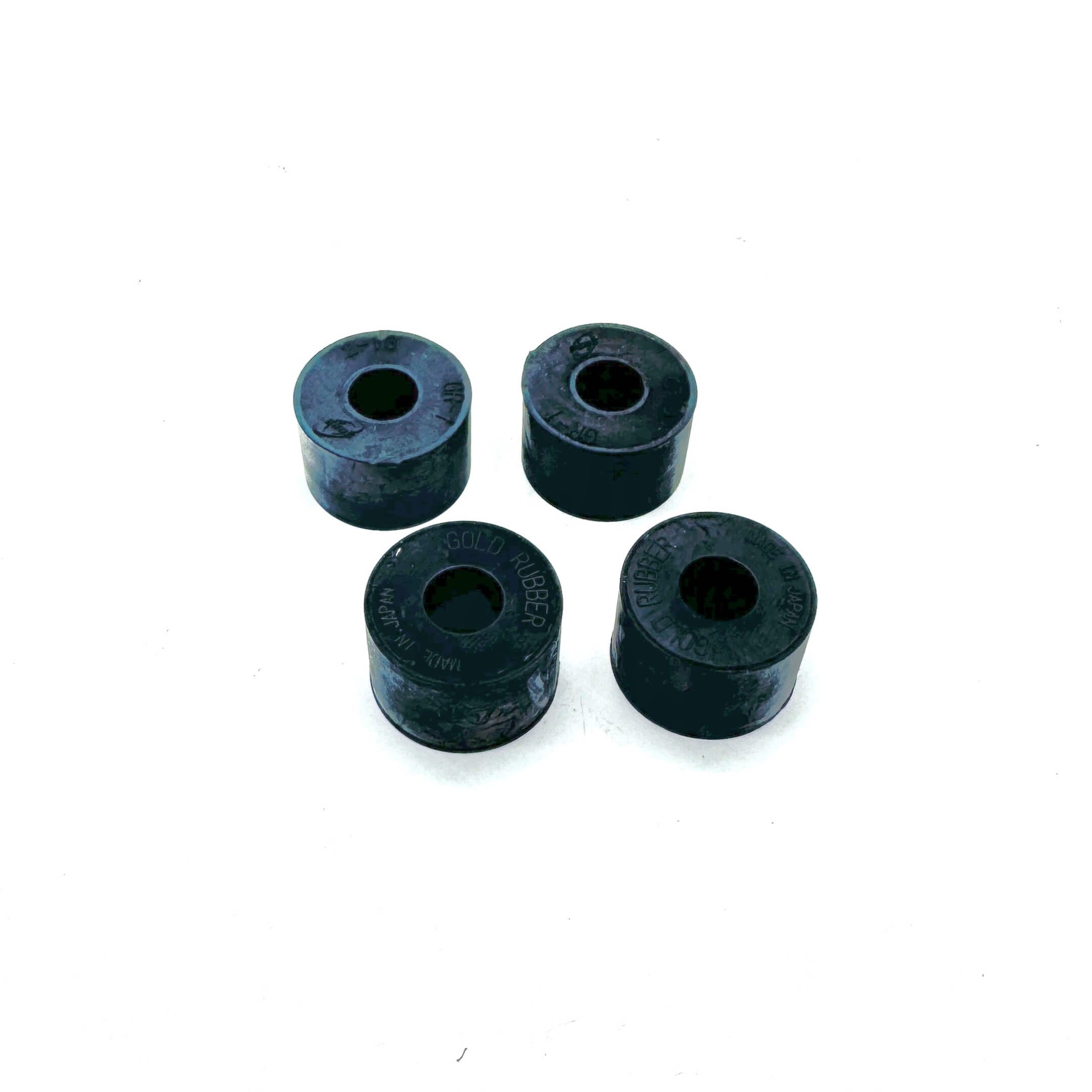 Four Rear Shock Absorber Grommets displayed at an angle, showcasing premium rubber construction for Honda Acty HA3 and HA4 (1990-1999).