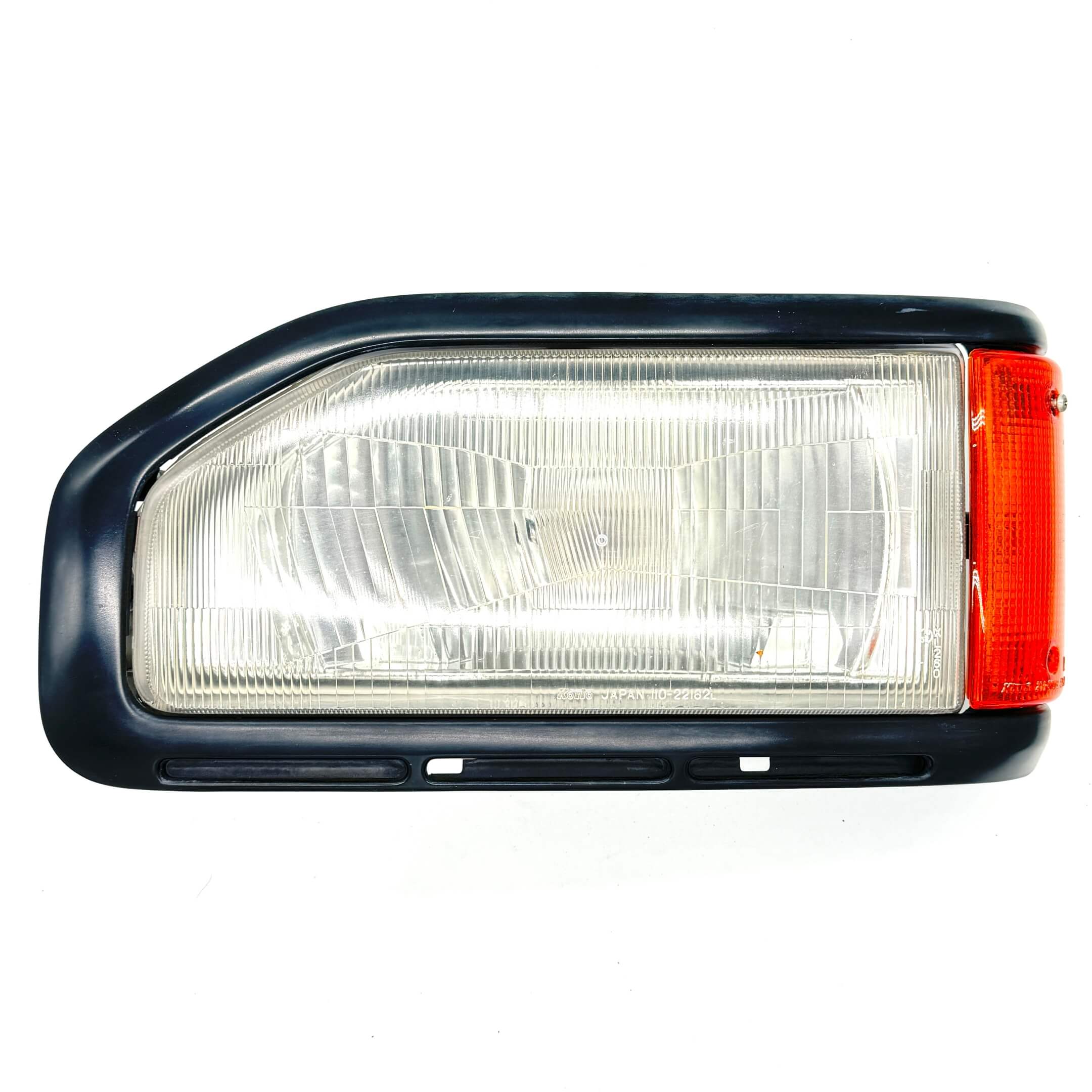 Side view of Left Headlight Assembly for Honda Acty Truck HA3, HA4 models (1990-1993) showing the detailed lens and indicator