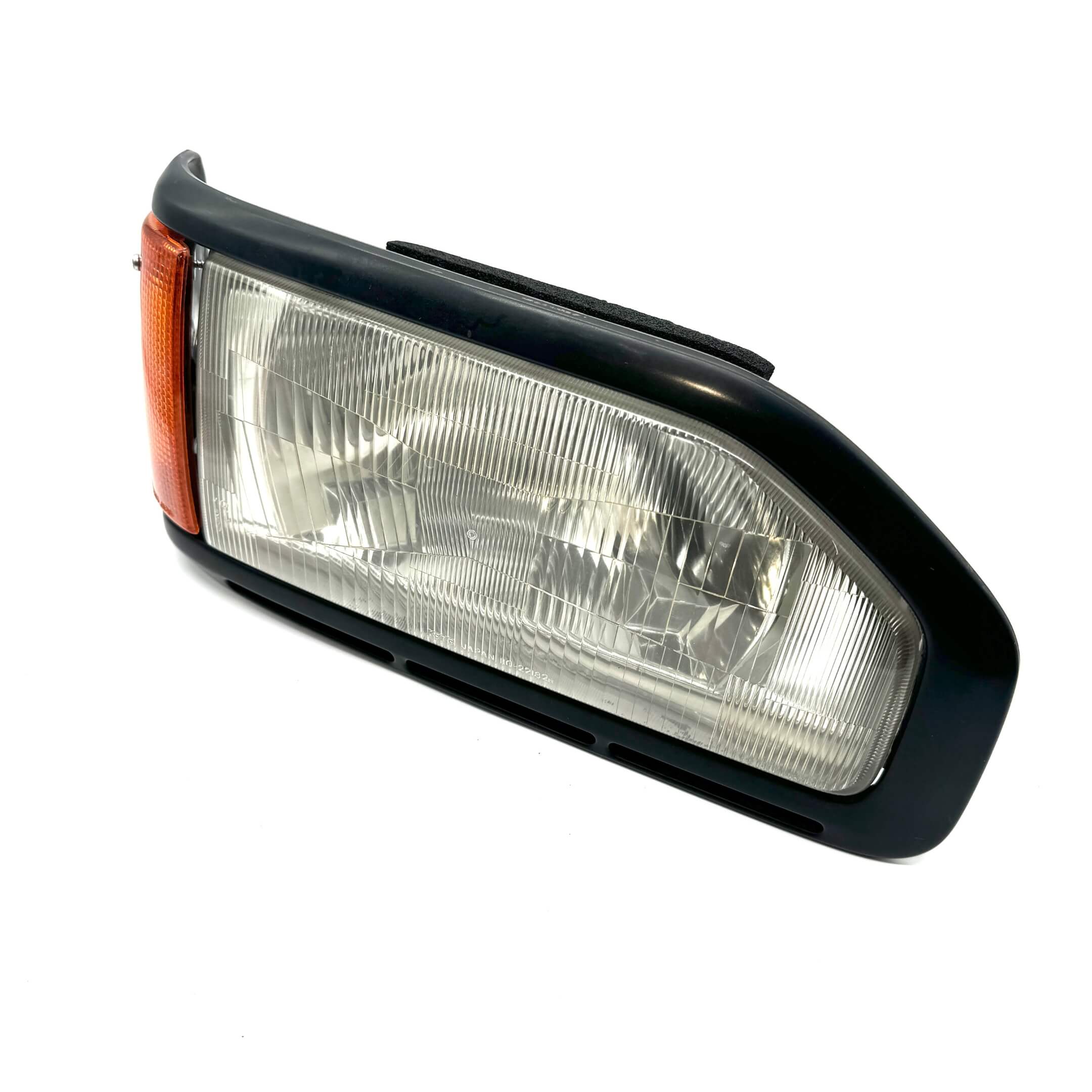 Angled view of right headlight assembly for Honda Acty Truck HA3, HA4 models 1990-1993, showcasing clear lens.