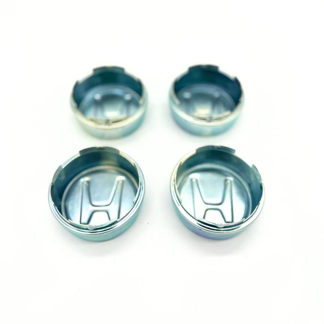 Honda Acty Truck Wheel Center Cap Set: Polished metal caps for HA3 and HA4 models, offering a snug fit to protect wheels, enhance aesthetics, and showcase Honda's 'H' logo for easy identification.