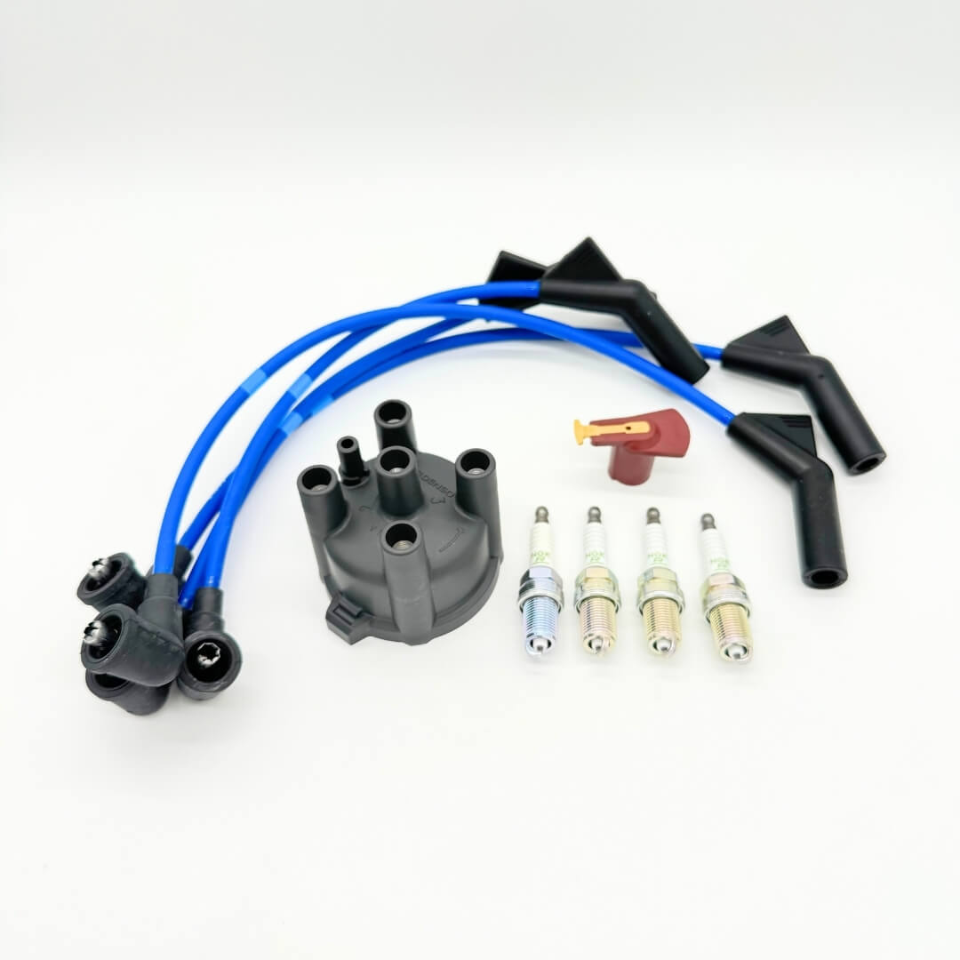 Complete 10-piece ignition kit for Subaru Sambar KV3/KV4 1990-1998 with distributor cap, rotor, high-performance spark plugs, and blue wires.