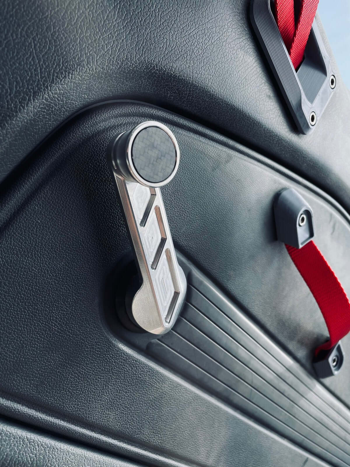 Installed Lusso design aluminum window crank handle in a Honda Acty Truck, demonstrating plug-and-play compatibility and enhanced interior aesthetics for models 1988-1999.