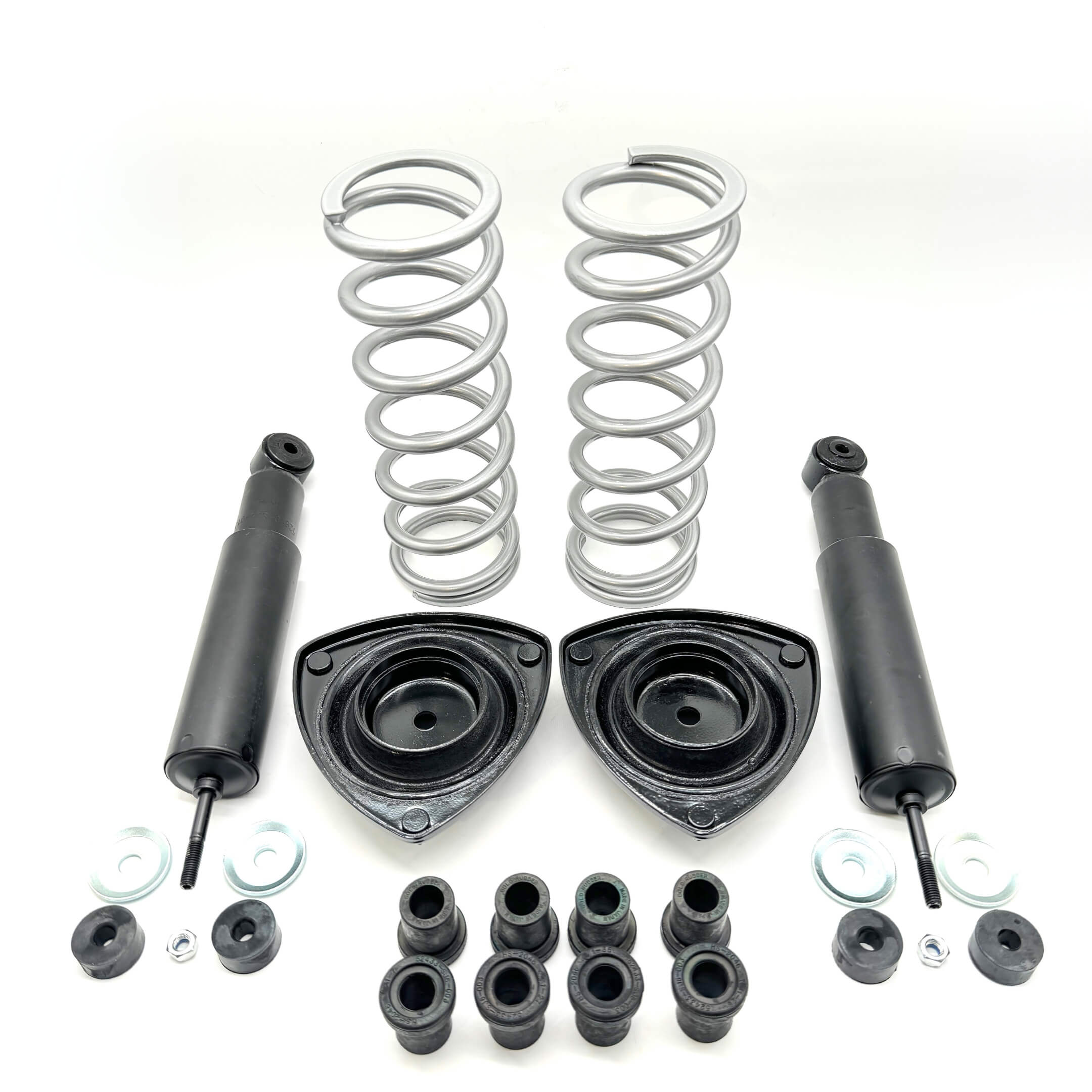 Detailed view of Honda Acty Truck suspension kit including silver coil springs, black shock absorbers, and mounting hardware for models 1990-1999.