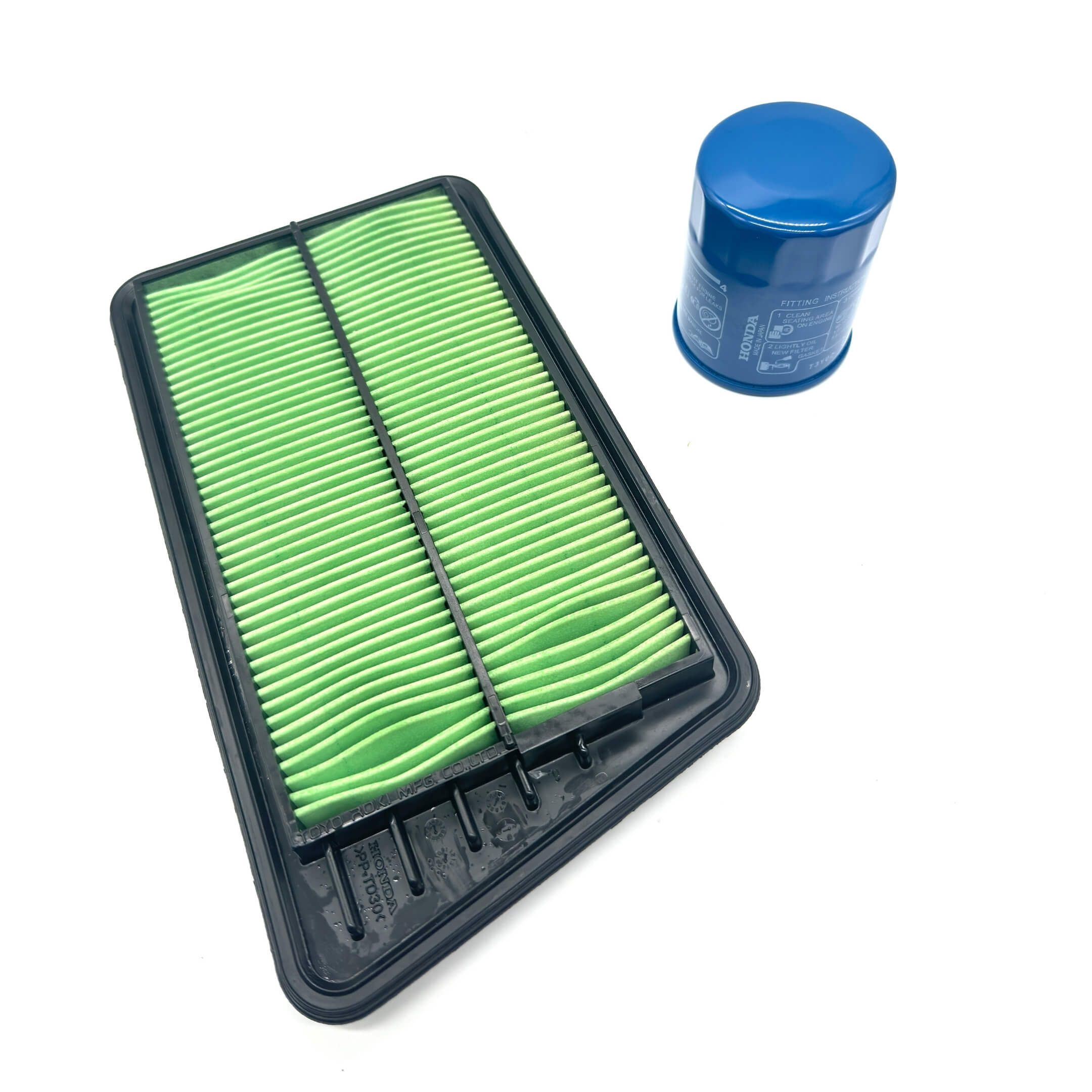 Genuine Honda 2 Piece Filter Package for Honda Acty Truck HA6, HA7 Models (1999-2009) featuring a green air filter and blue oil filter.