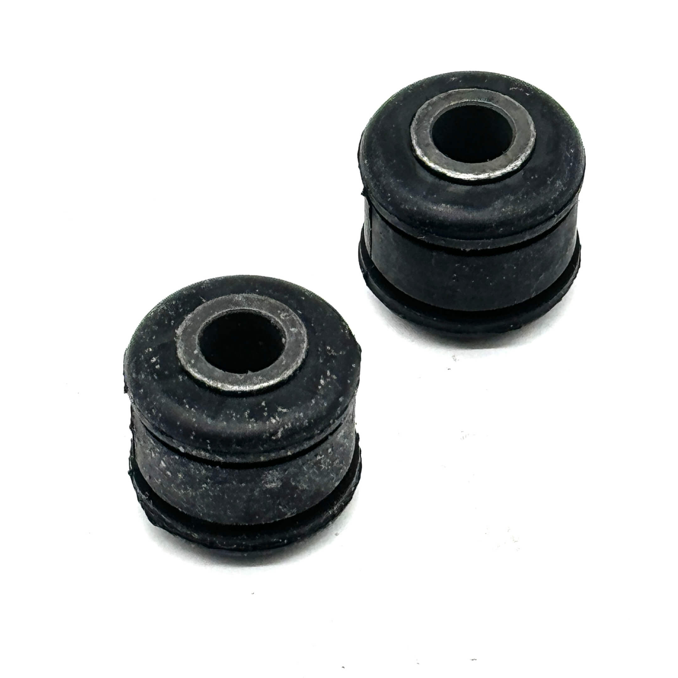 Angled view of two rear shock bushings for Honda Acty HA6, HA7 models, designed for improved suspension performance.